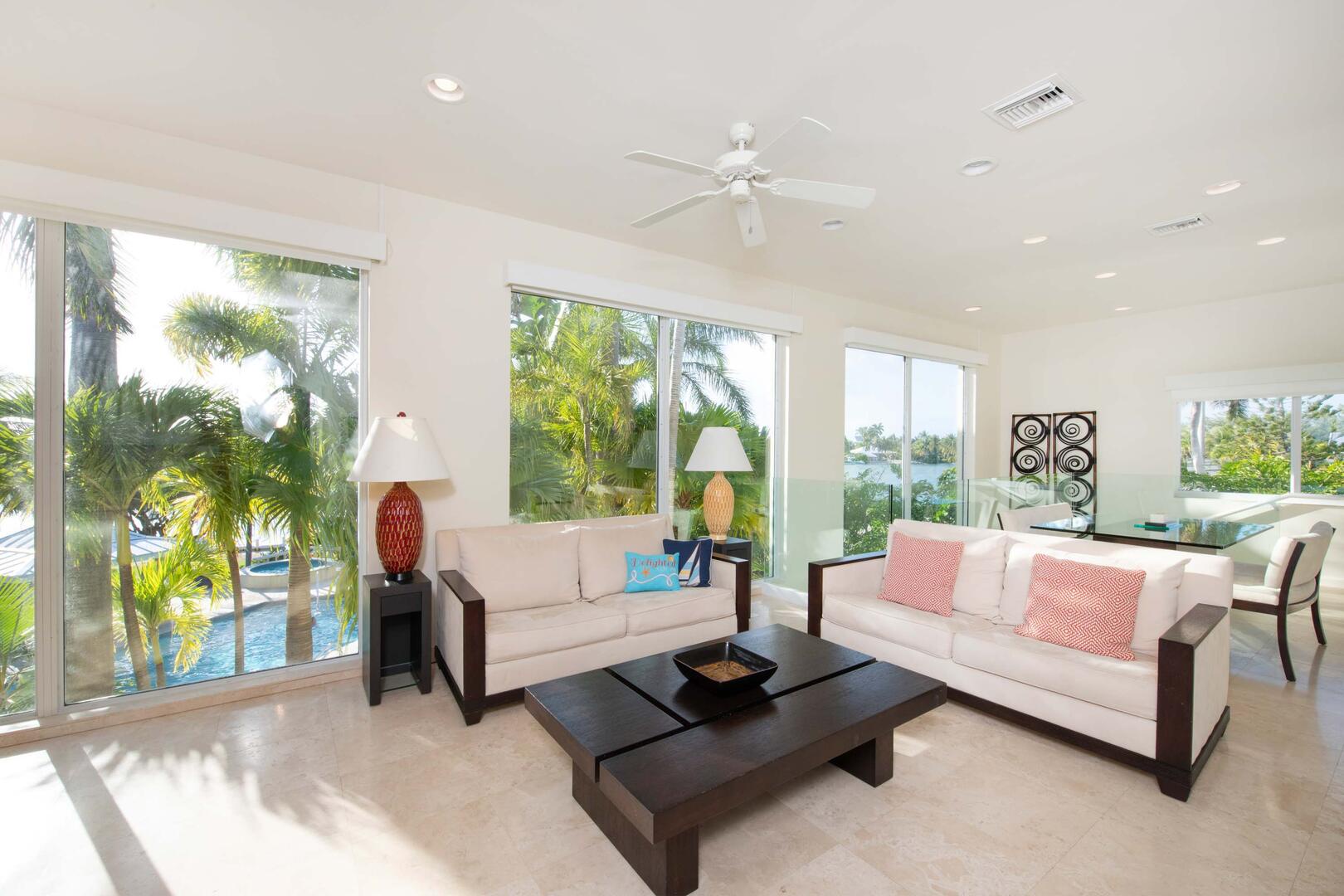 Guest Suite's living area with floor to ceiling windows and modern furniture.