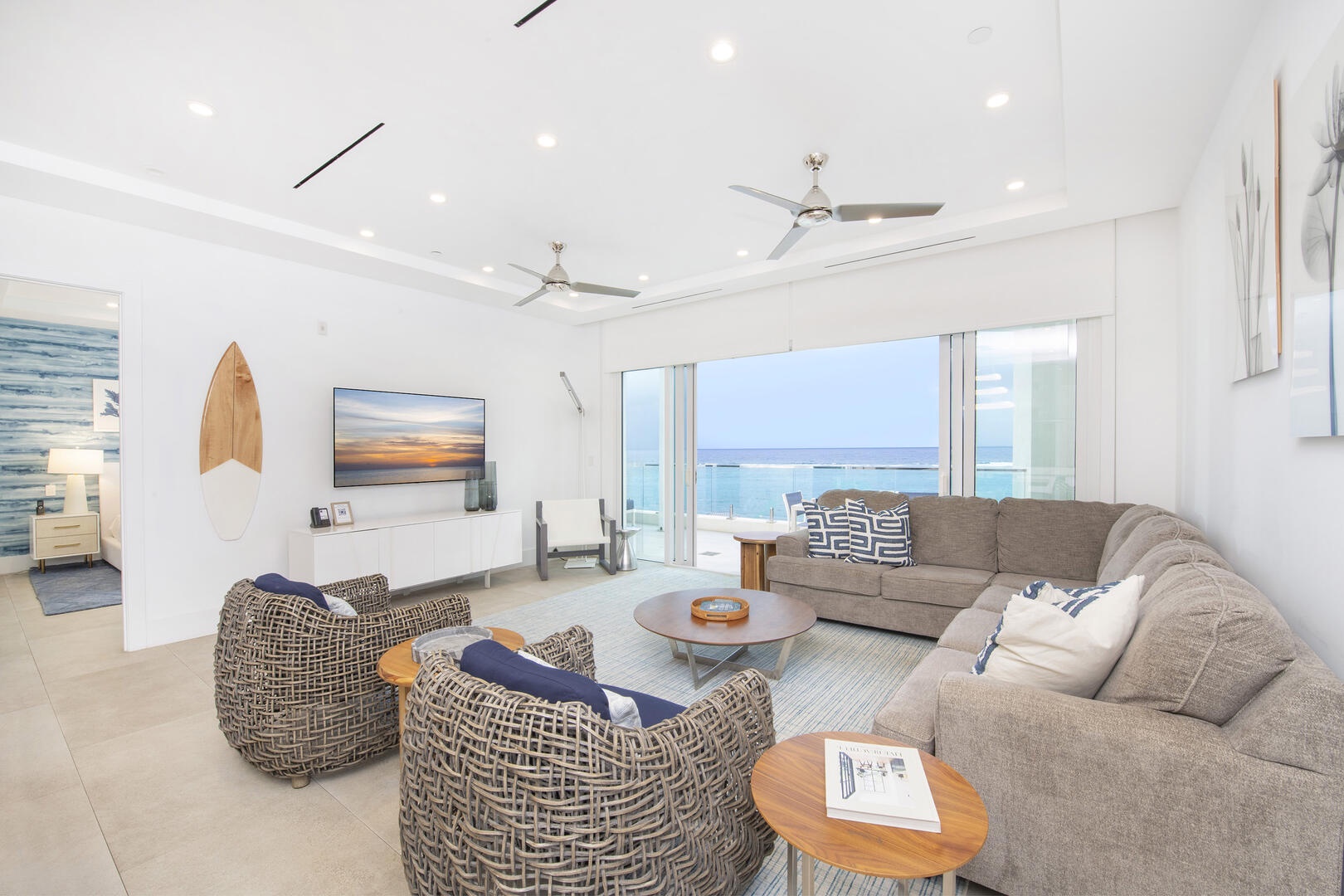 Spacious living area with modern decor and furniture.