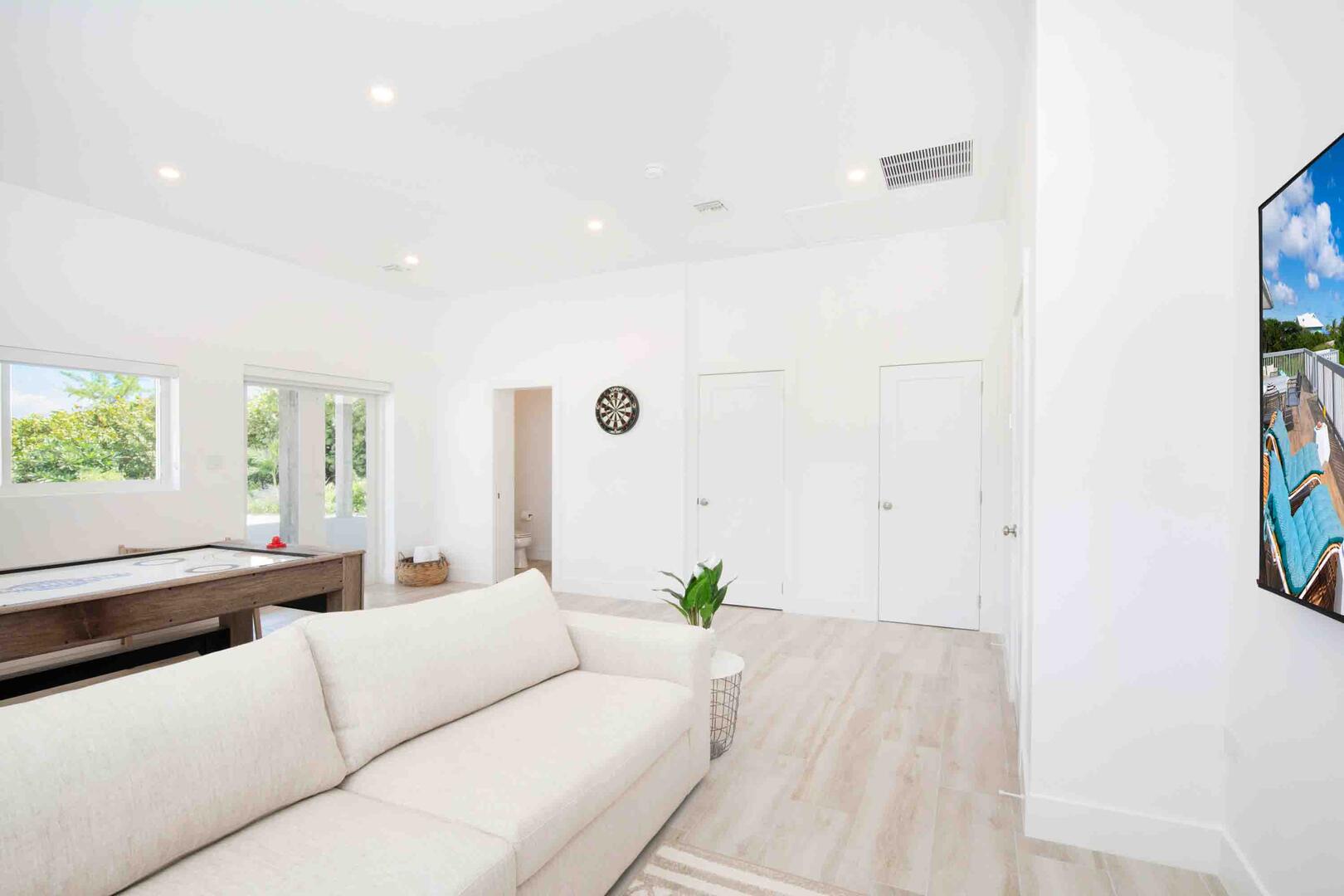 The lower level den is furnished with a sleeper sofa, a wall mounted SmartTV, and a full bathroom with shower. The sleeper sofa is reserved for children only.