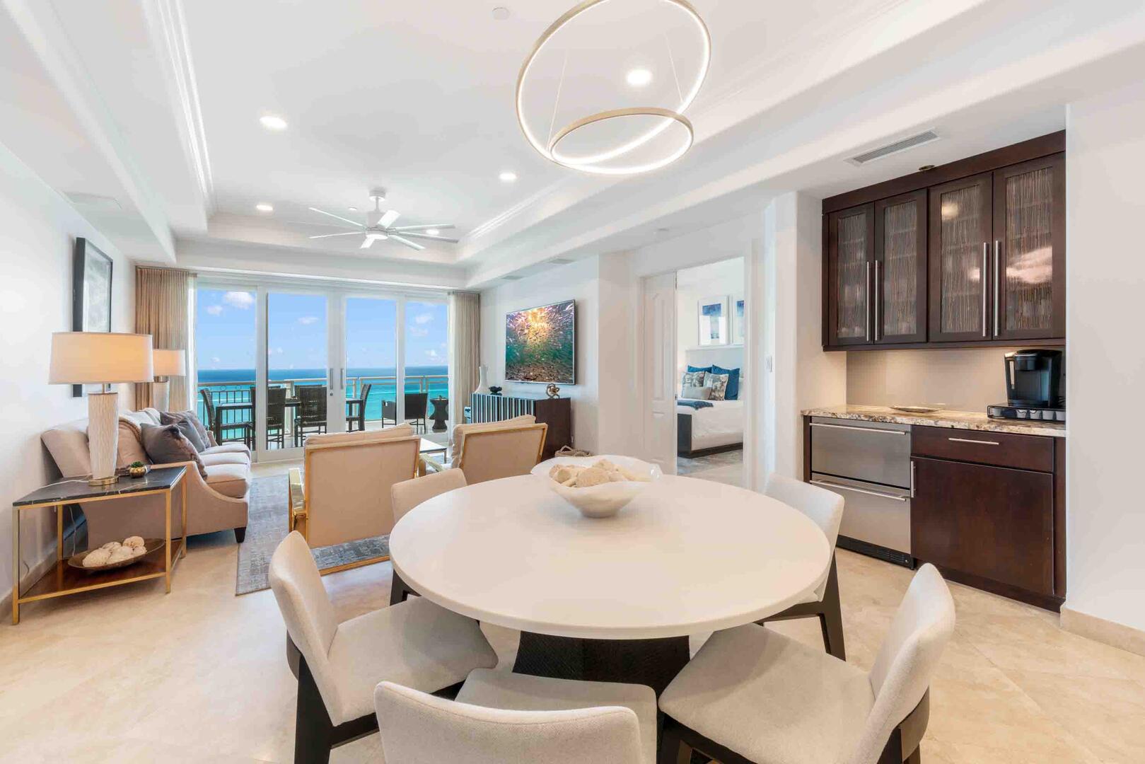 Formal dining table with adjacent coffee bar equipped with a Keurig and chilled beverage drawers.