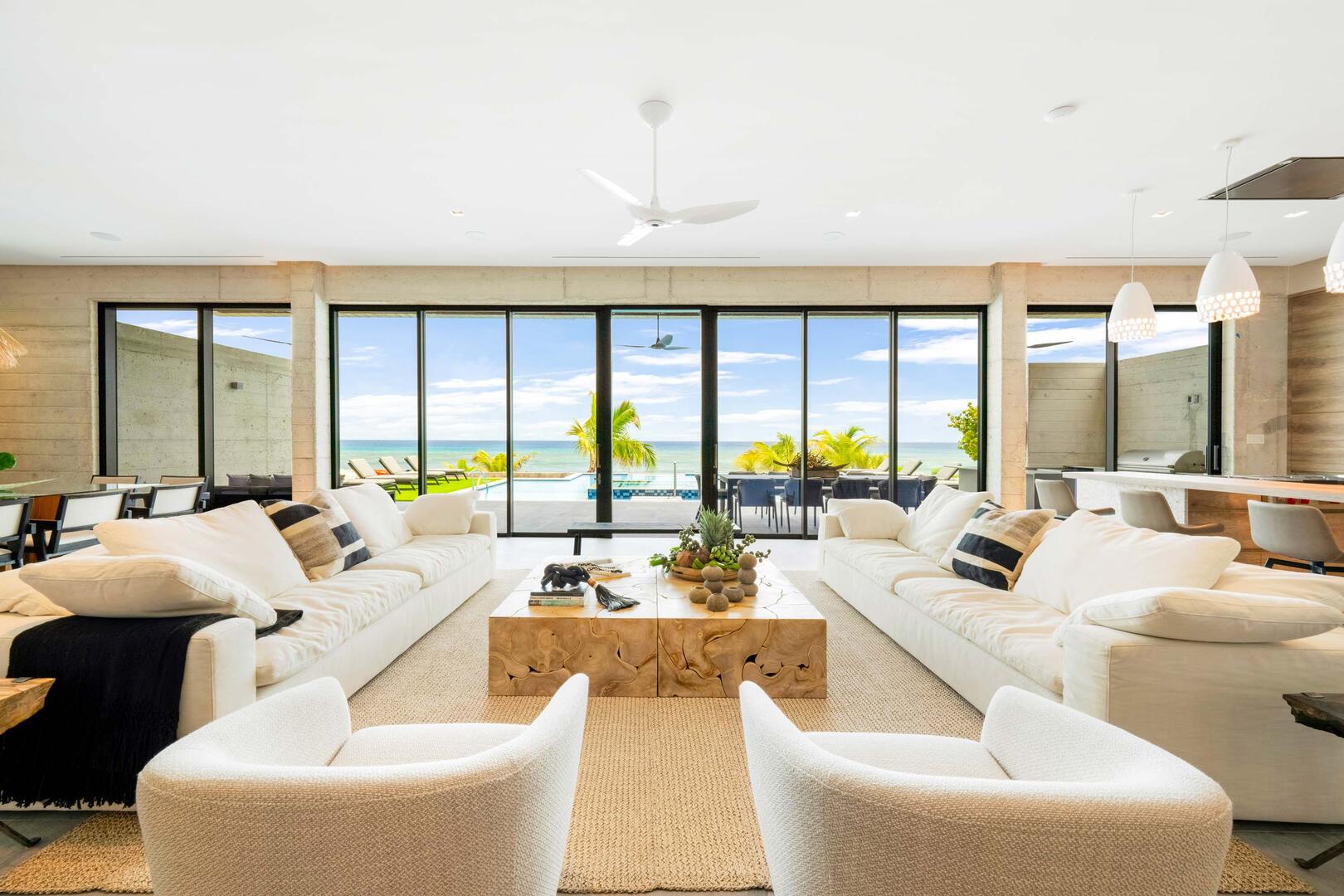 Great room with tall oceanfront windows and sliding glass doors