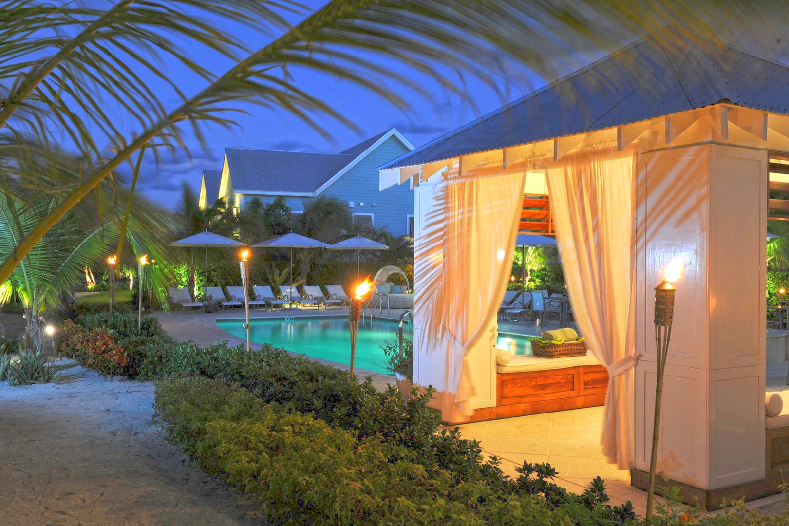 Cozy pool cabana at dusk.