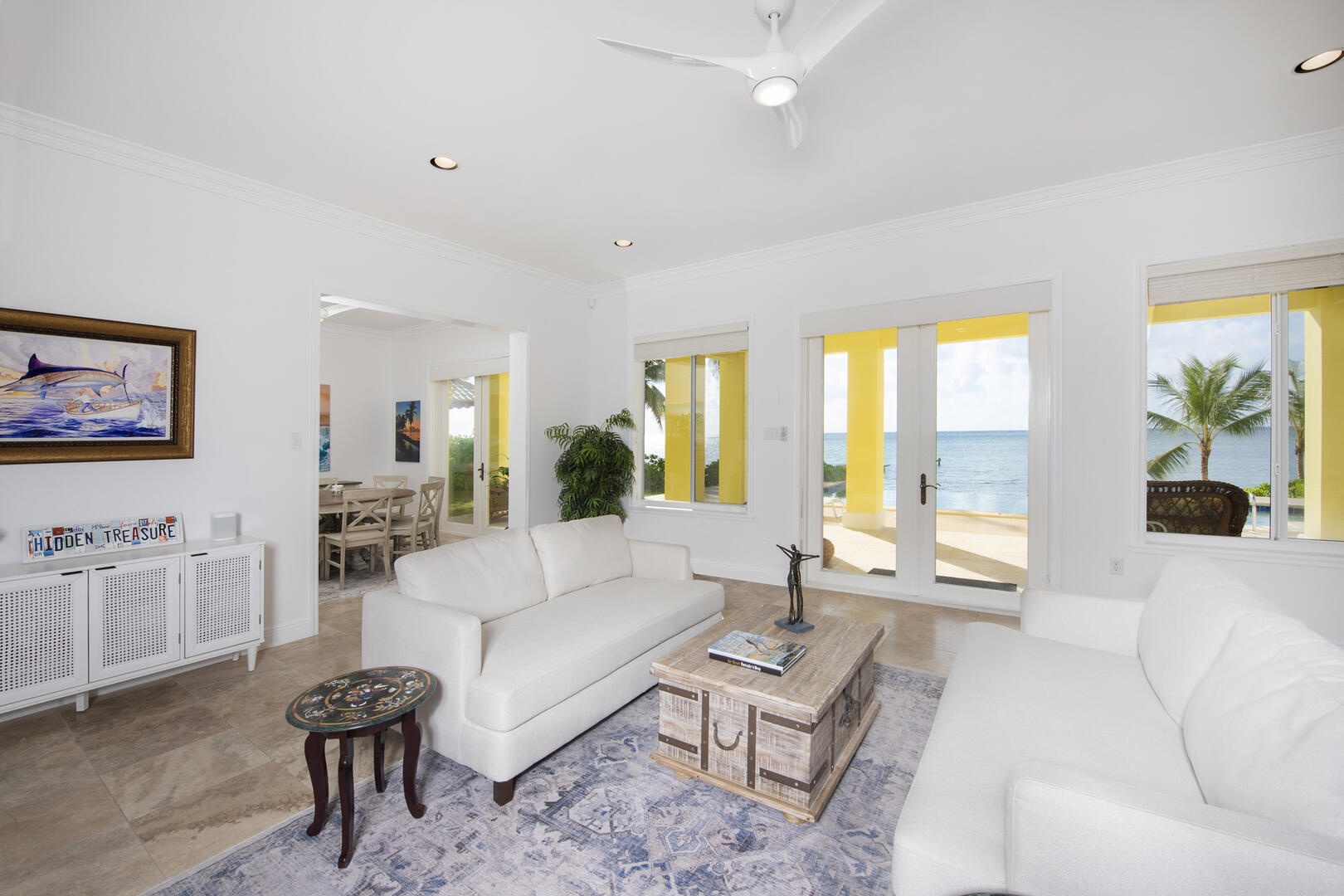 Lower level living areas with plush sofas and walk-out access to the pool deck.