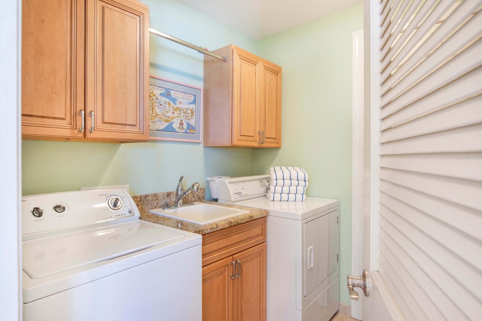 In-unit laundry room with washer and dryer.