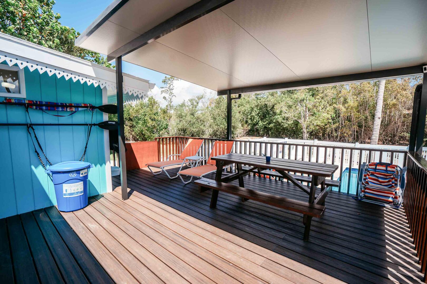Rear deck with shade cabana plus a picnic table and beach chairs.