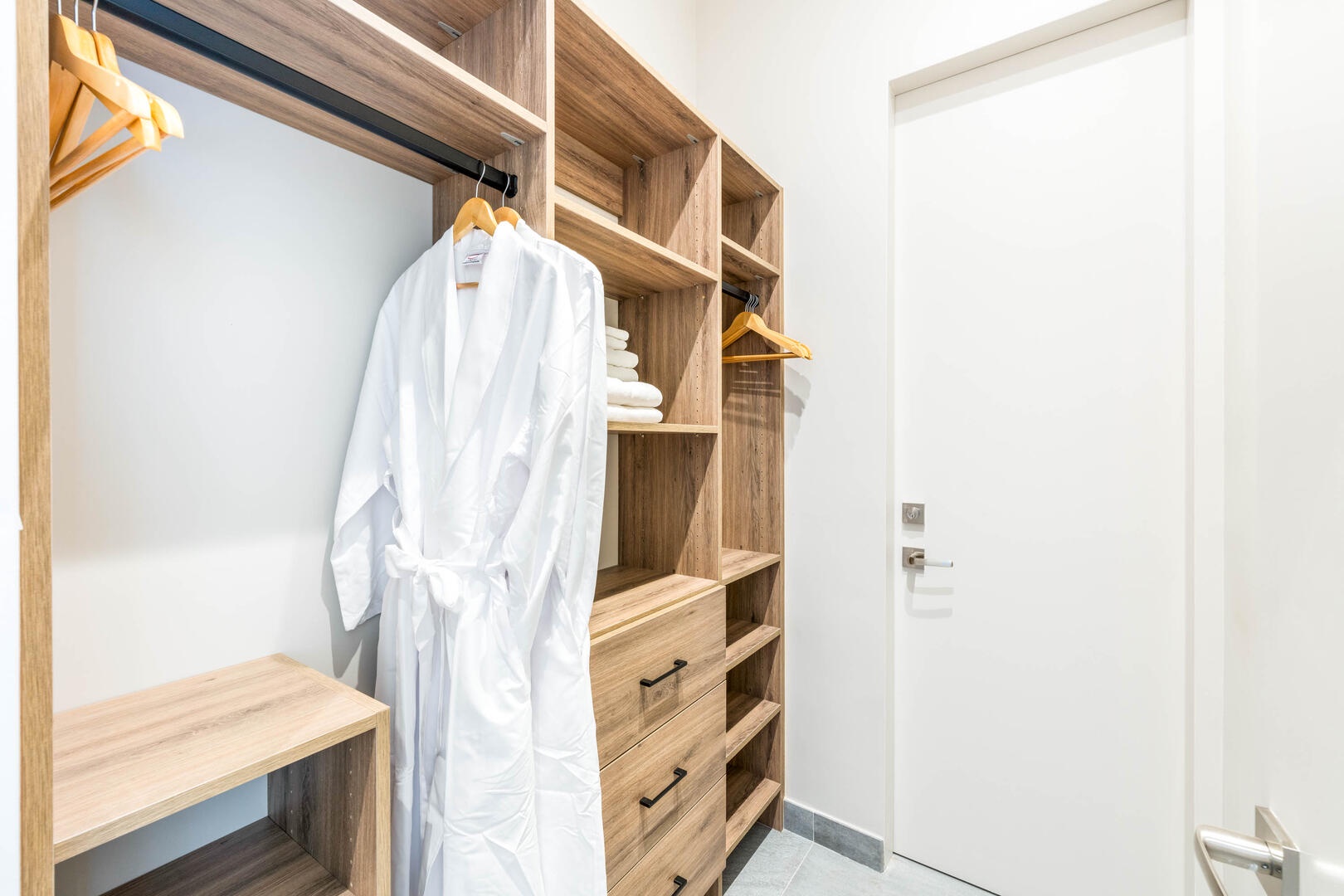 Suite 1 ensuite bathroom with double vanity, multiple mirrors, lighted make-up station, walk-in oceanview shower