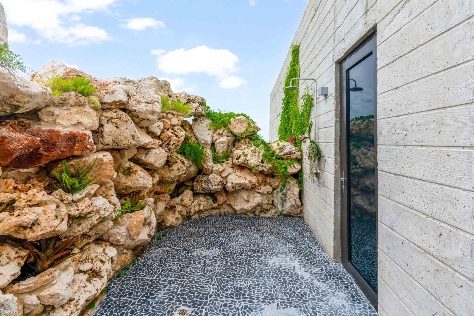 Outdoor rock wall shower