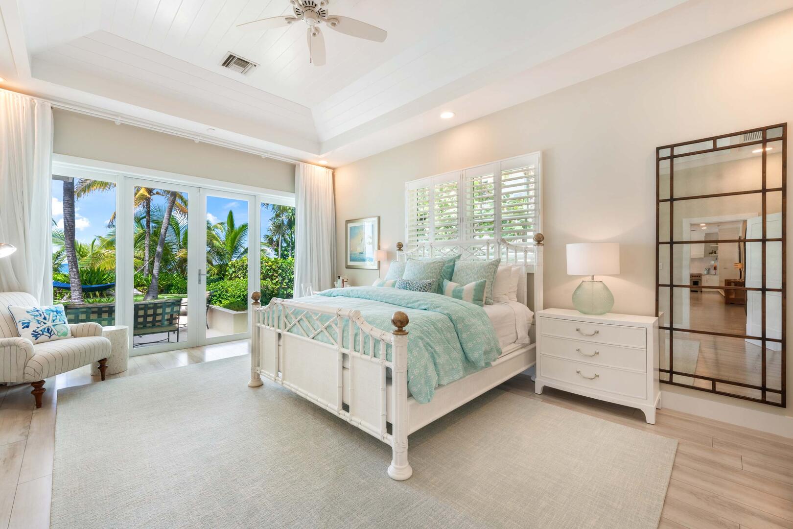 Primary suite with king bed and walk-out access to the pool deck.