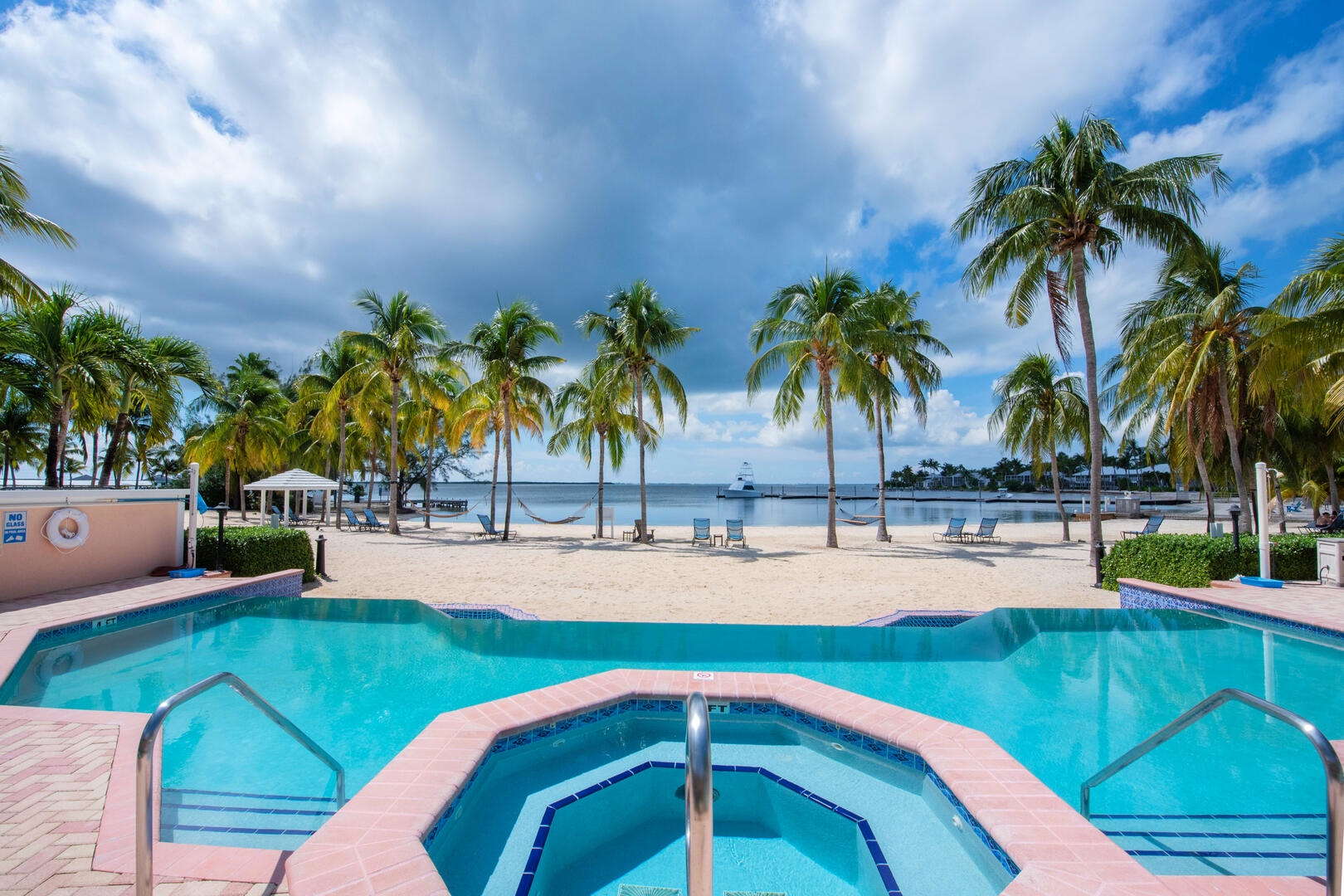 Communal pool and spa overlooking the beach.