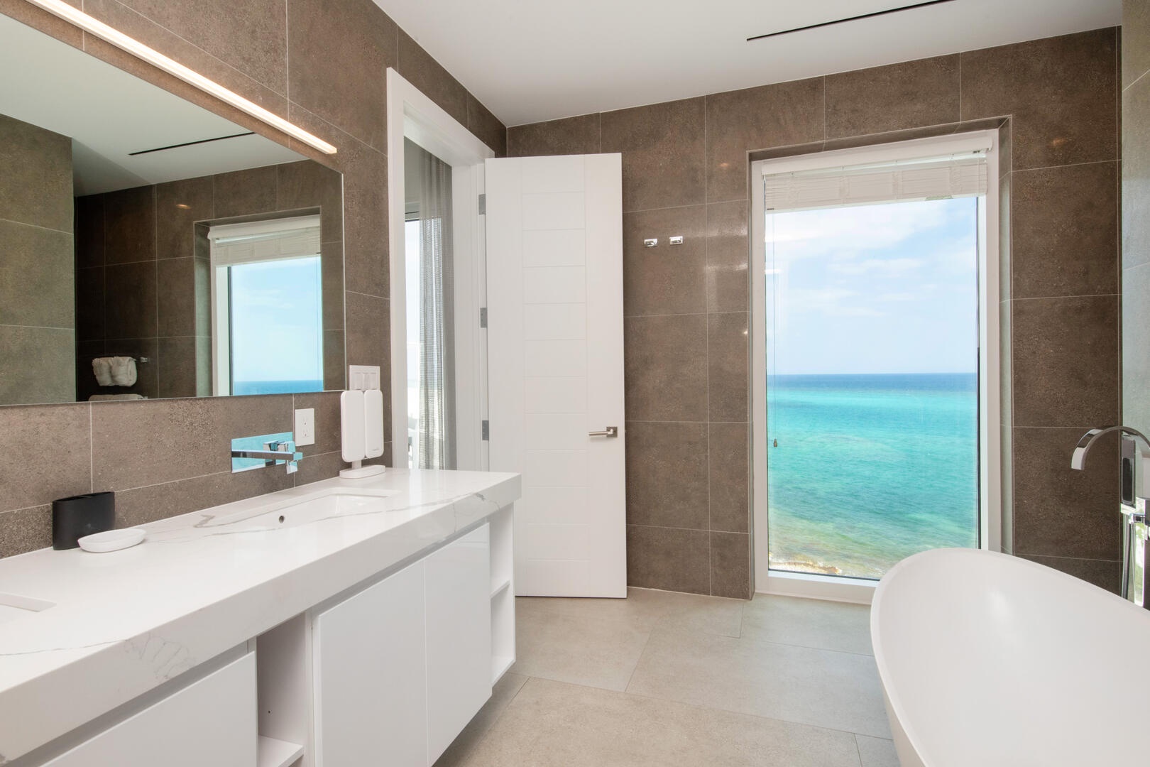 Primary ensuite bath with dual vanity, soaking tub, and walk-in shower.