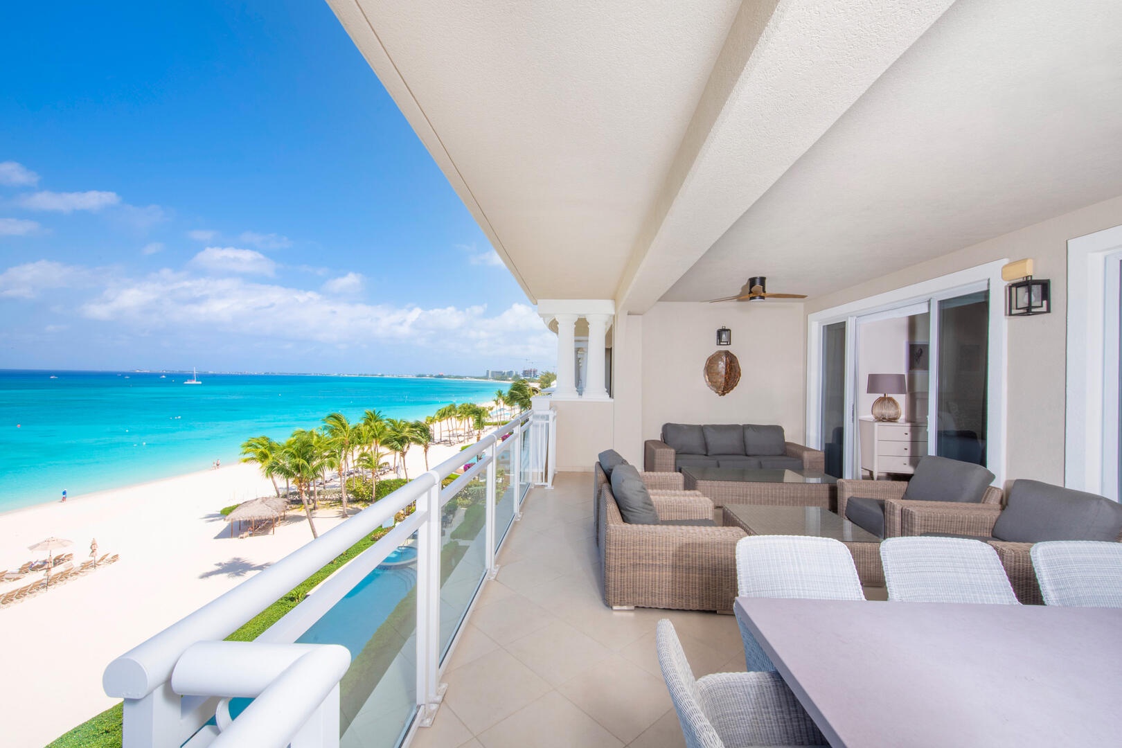 Private furnished balcony with elevated beachfront views.