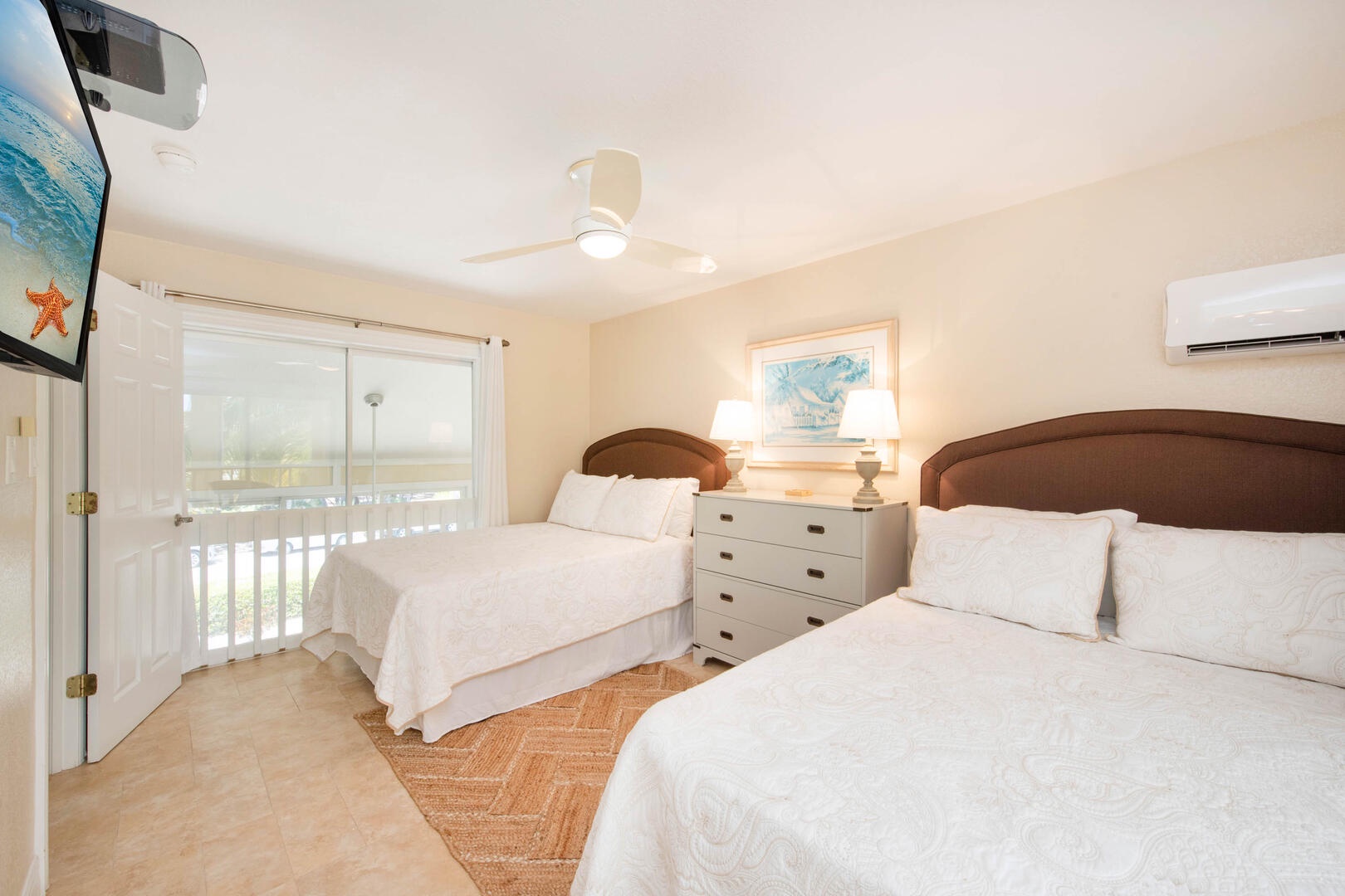 Guest suite with 2 full beds, television, and remote air conditioning.