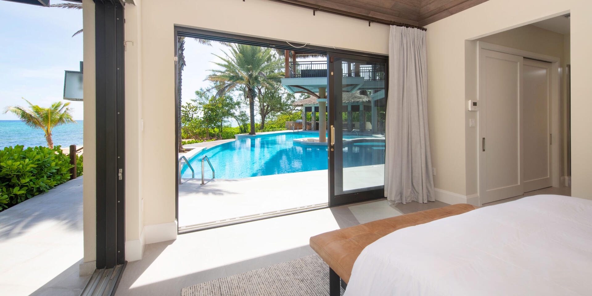 Bedroom 3 enjoys walkout access to the pool deck and beachfront.