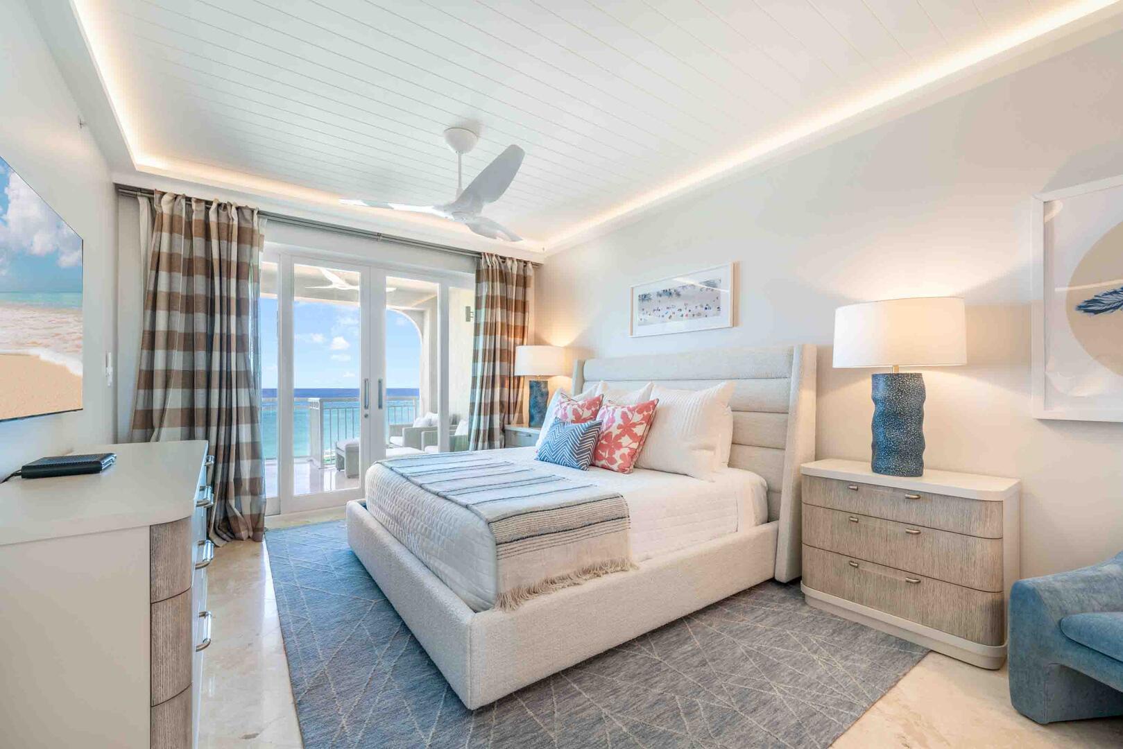 Primary Suite with king bed, HD television, and walk out access to the ocean balcony.