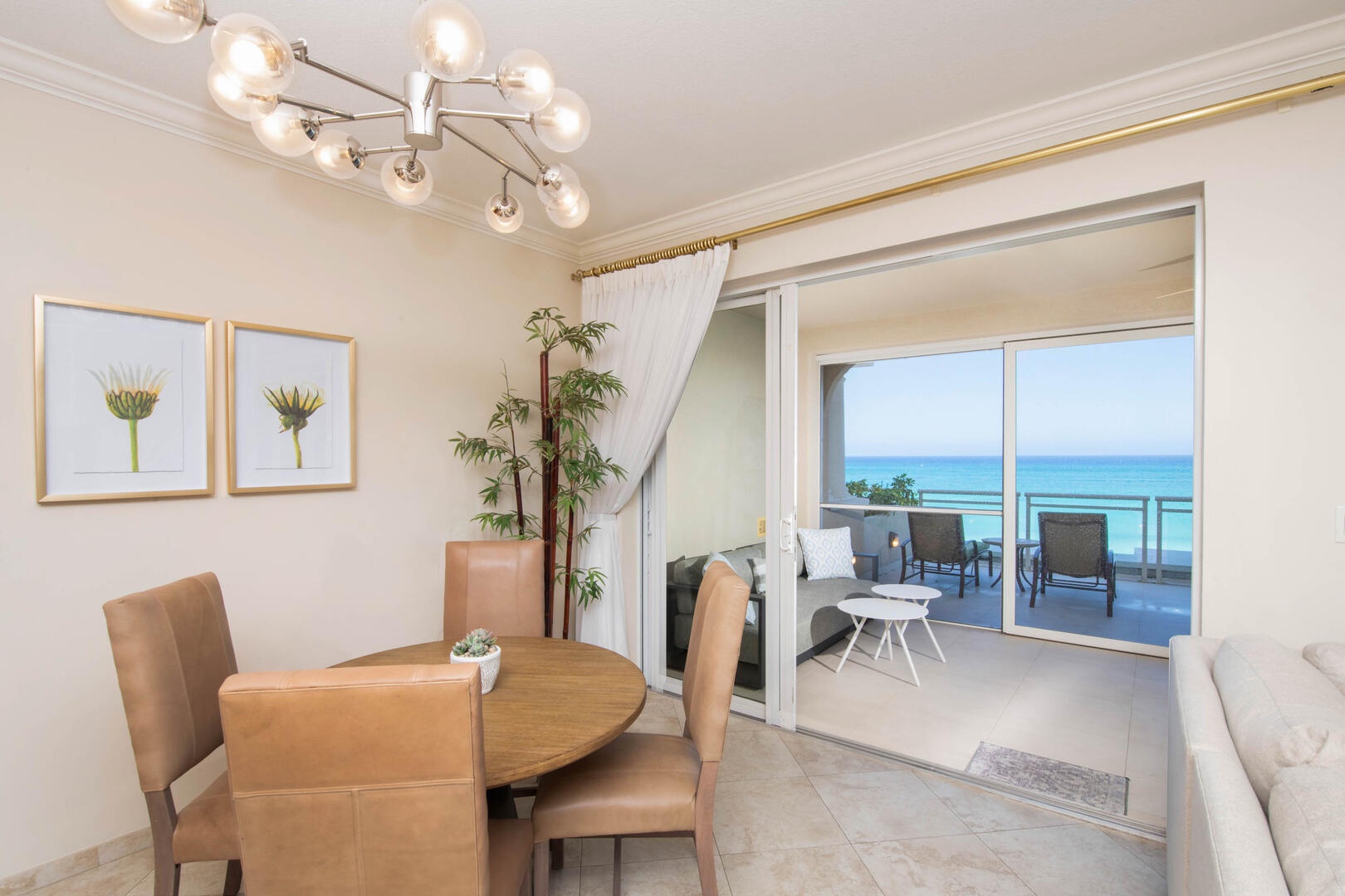 Formal dining table with seating for 4. Another dining table sits on the screened balcony for meals with oceanfront views.