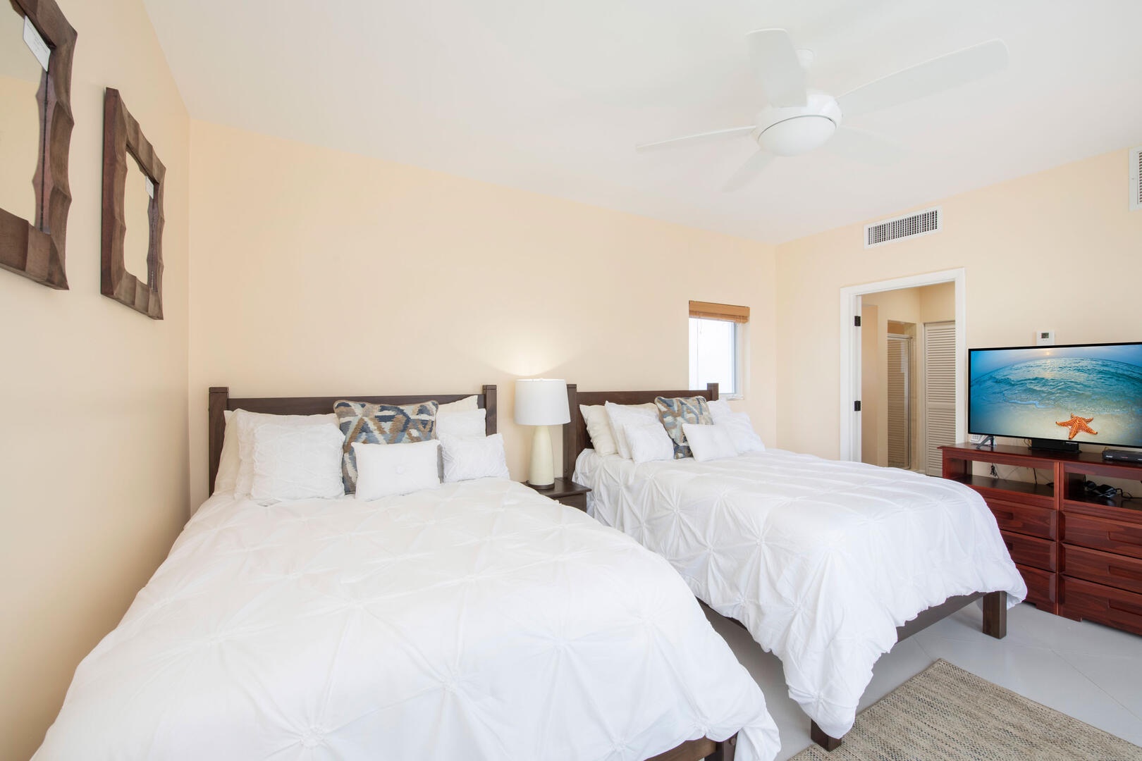 Guest Suite furnished with two double beds and an HD television.