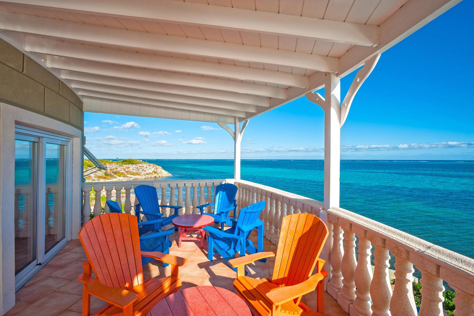 Adirondack chairs on the balcony off the great room overlooking the ocean.
