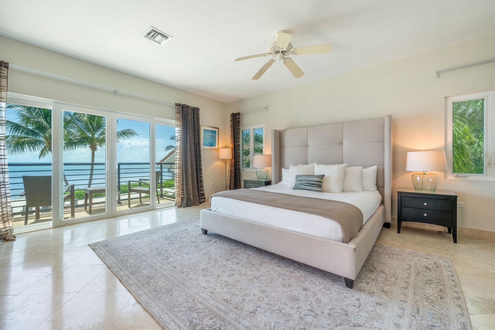 West Primary Suite with king bed and private balcony.