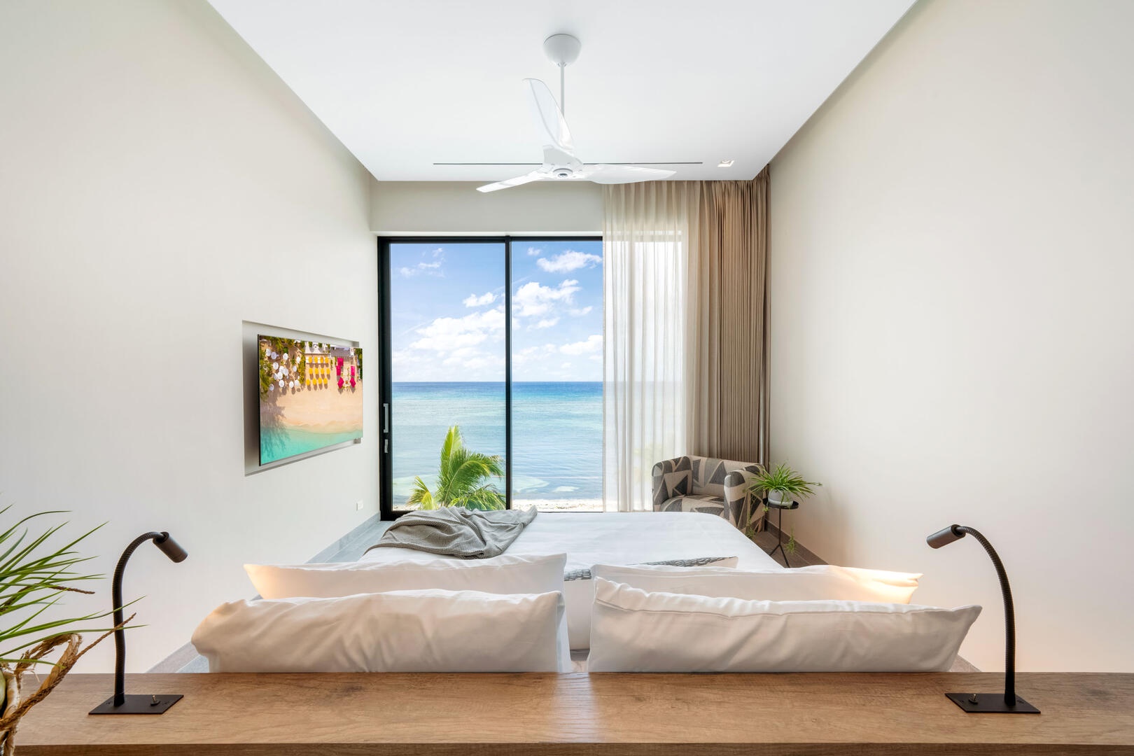 Oceanfront king suite 3 - king platform bed, desk, oceanfront floor-to-ceiling glass doors, 65" TV w/swivel mount, beverage fridge, coffee center, upholstered chair, sofa