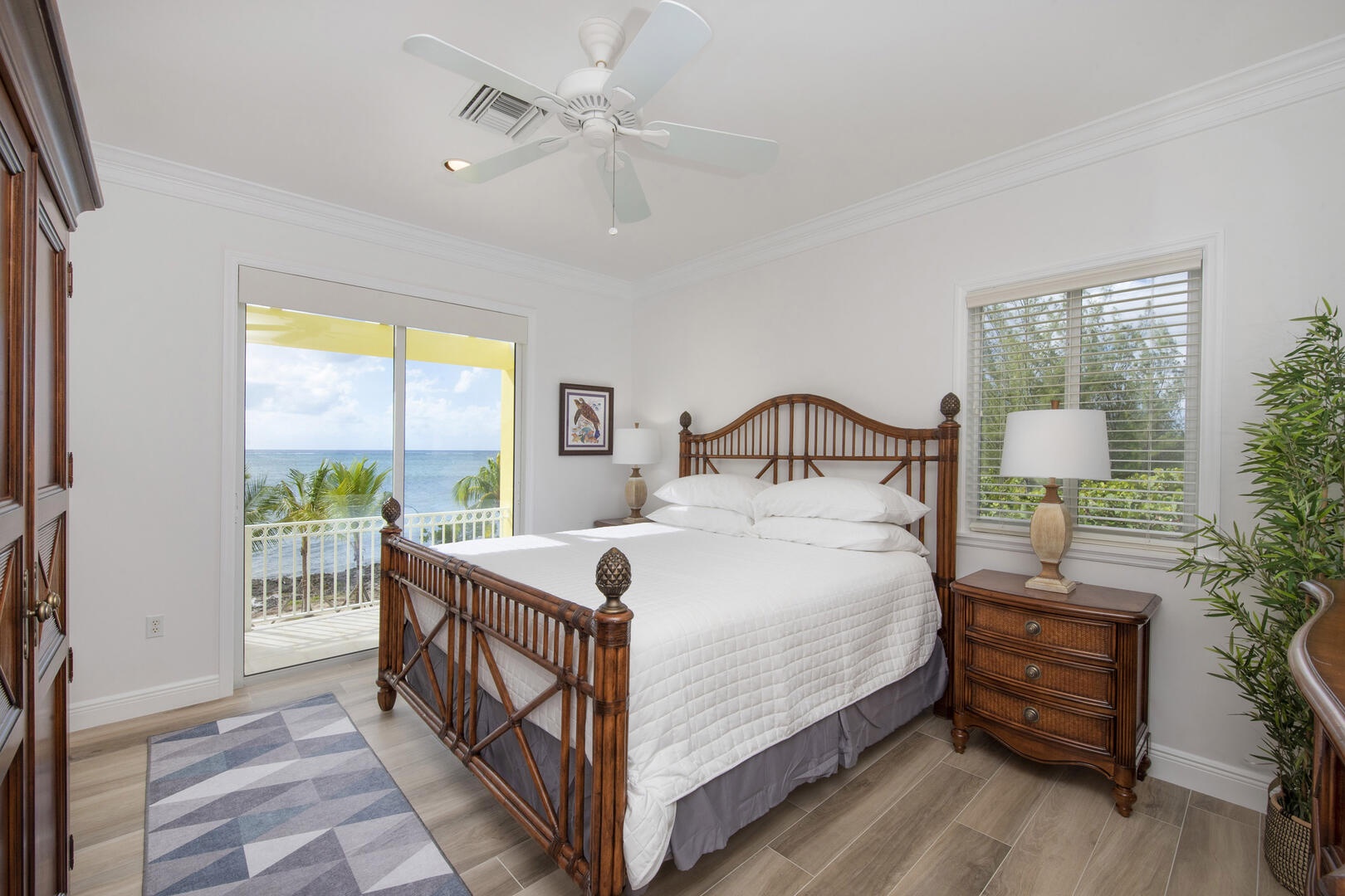 Bedroom 2 is the primary suite with king bed, television, and walk-out access to the dining balcony.