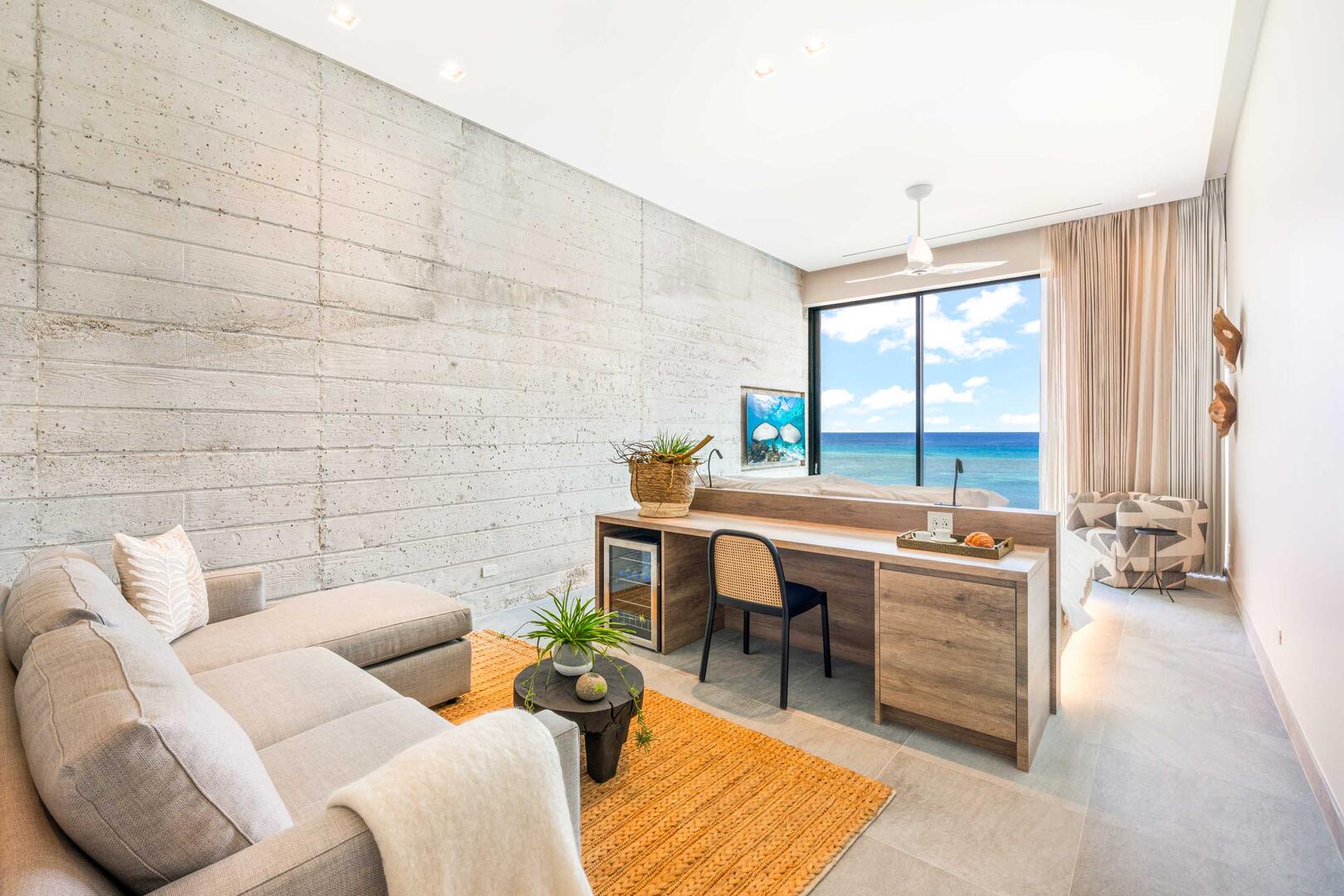 Oceanfront king suite 1 - king platform bed, desk, oceanfront floor-to-ceiling glass doors, 65" TV w/swivel mount, beverage fridge, coffee center, upholstered chair, sofa