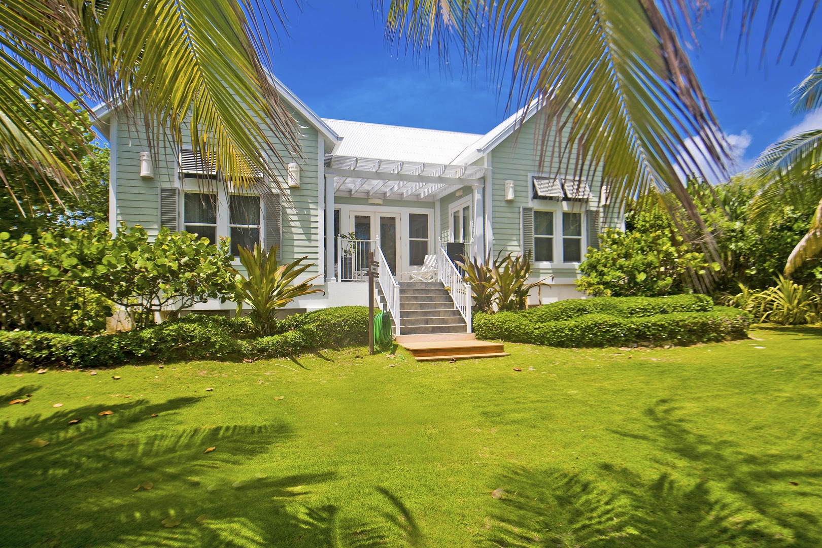 Avocado Cottage's exterior has a bright beach bungalow look to it.