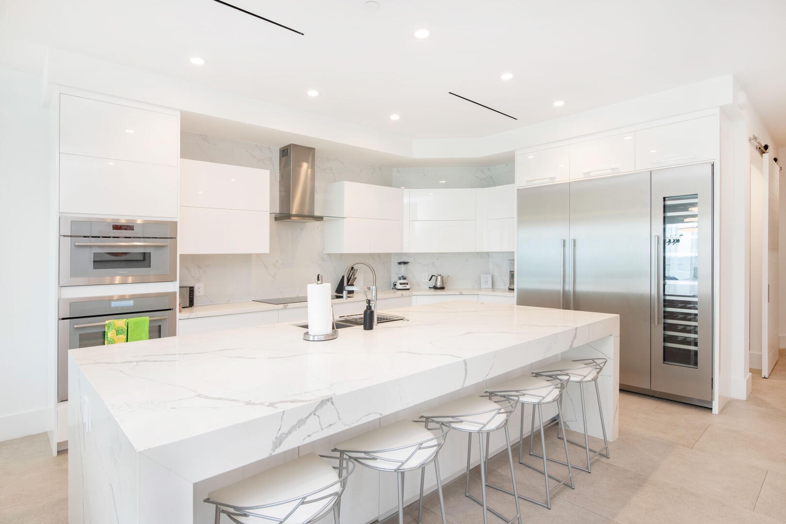 Gourmet kitchen with top-of-the-line appliances and kitchen island seating.