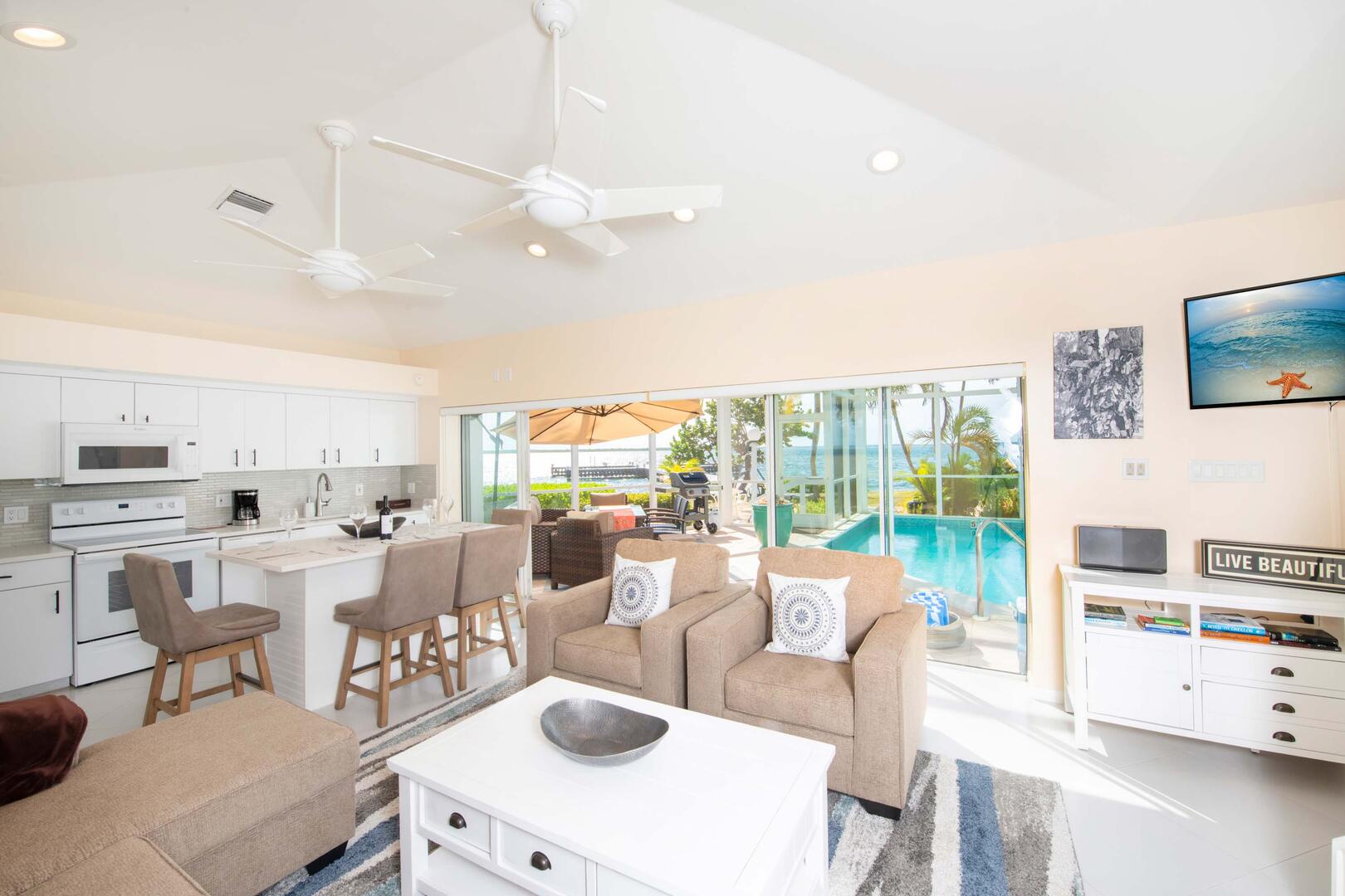 Living, dining, and kitchen areas highlighted by bright coastal decor.
