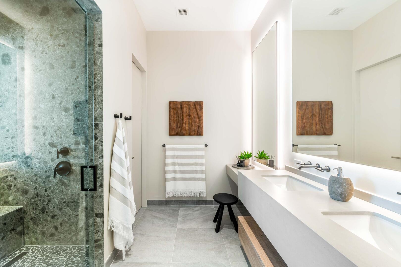 Suite 2 ensuite bathroom with double vanity, multiple mirrors, lighted make-up desk, walk-in oceanview shower