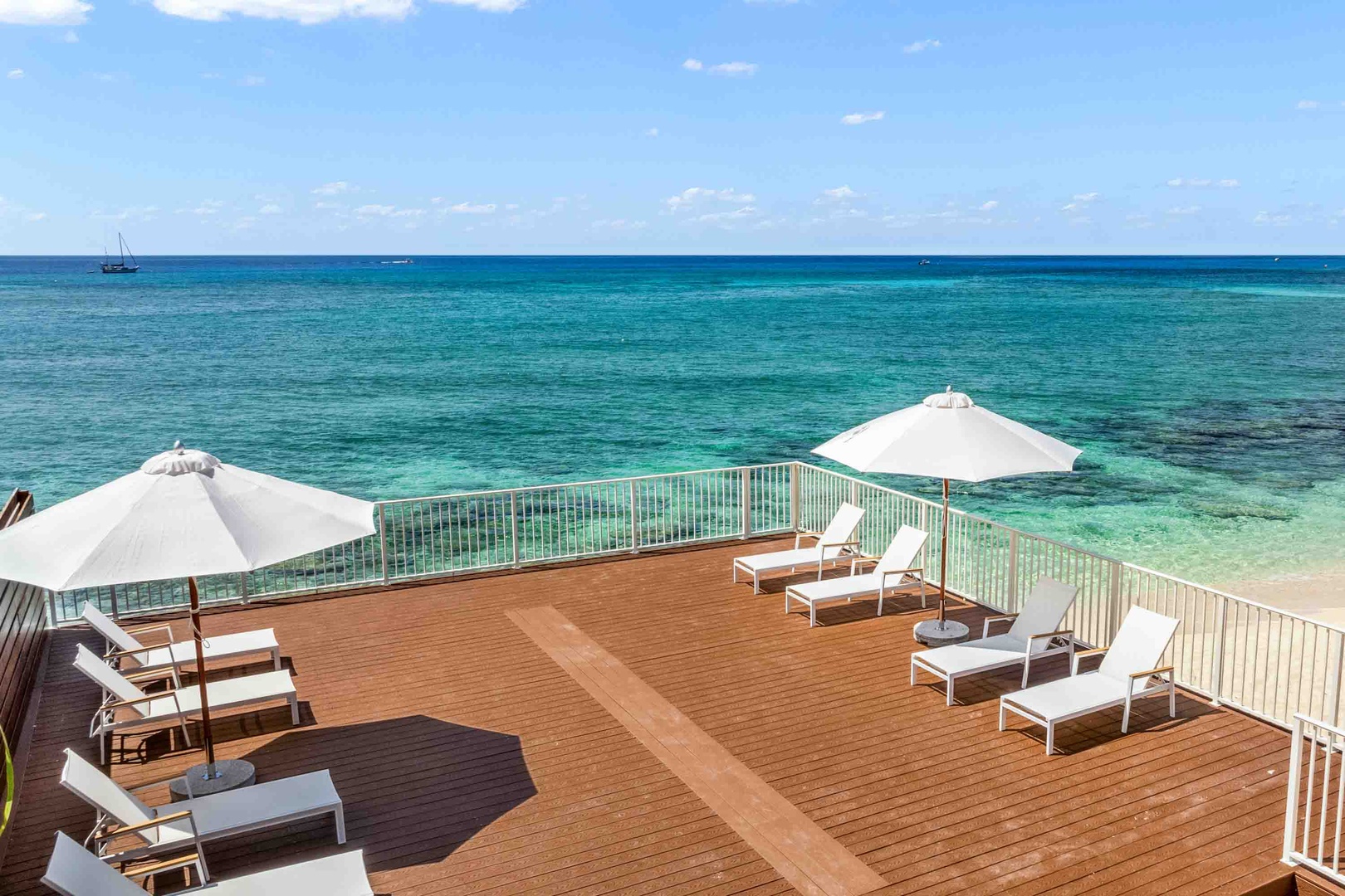 The beach deck is furnished with sun beds and sunbrellas.