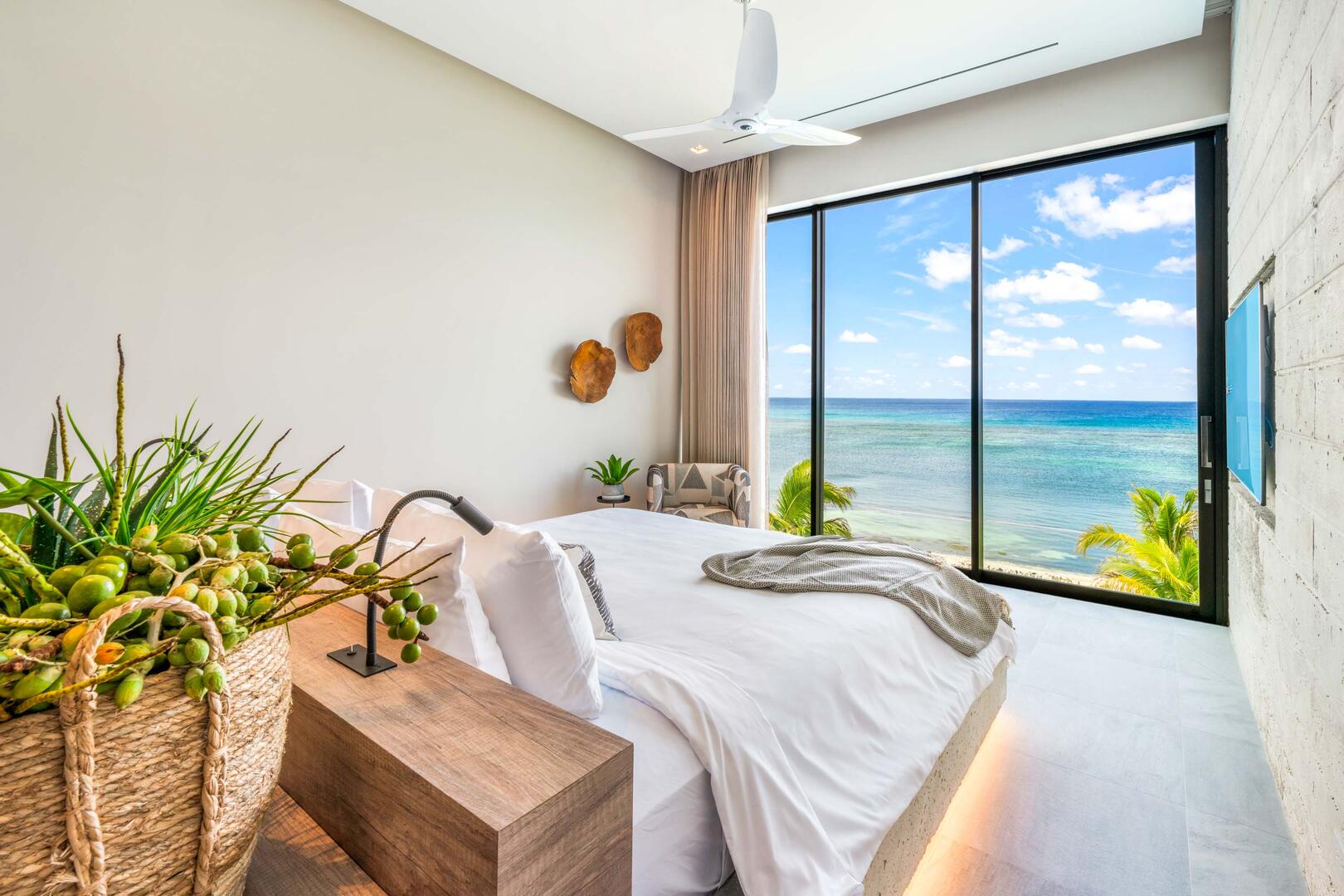 Oceanfront king suite 4 - king platform bed, desk, oceanfront floor-to-ceiling glass doors, 65" TV w/swivel mount, beverage fridge, coffee center, upholstered chair, sofa