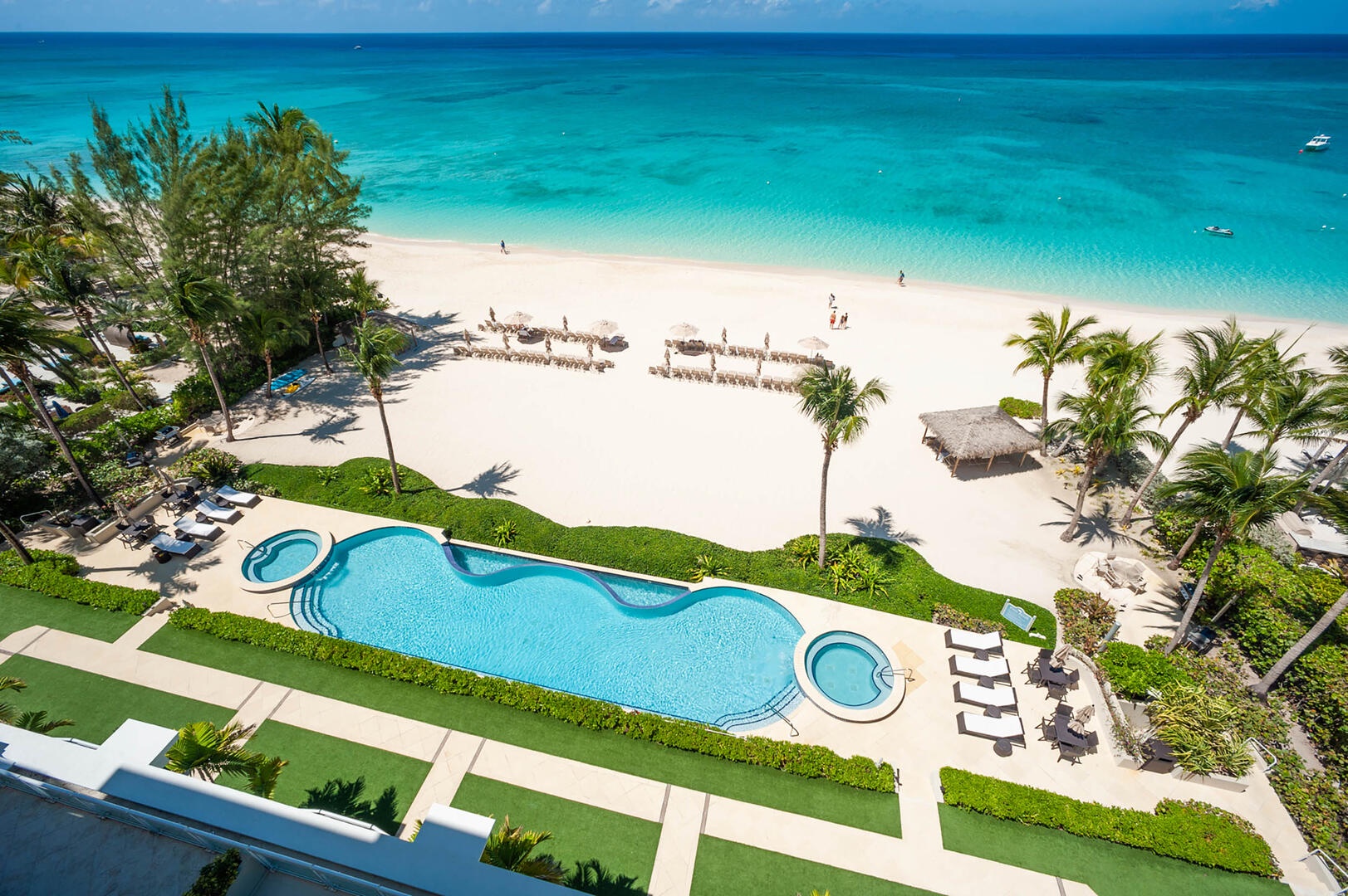 Aerial view of the resort's pool, heated spas, and dreamy beachfront.