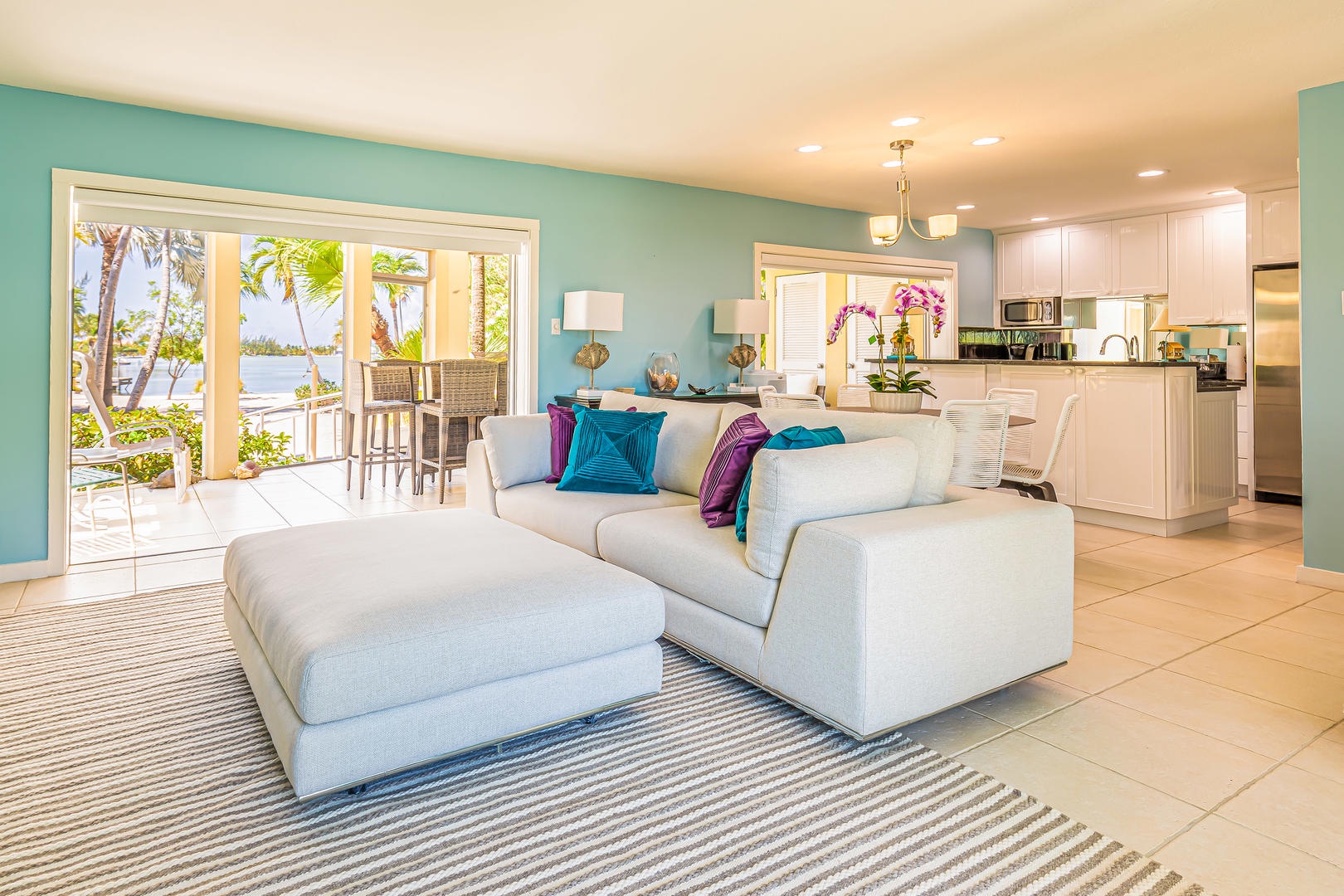 Living area and kitchen opens out to the two-story screened lanai.