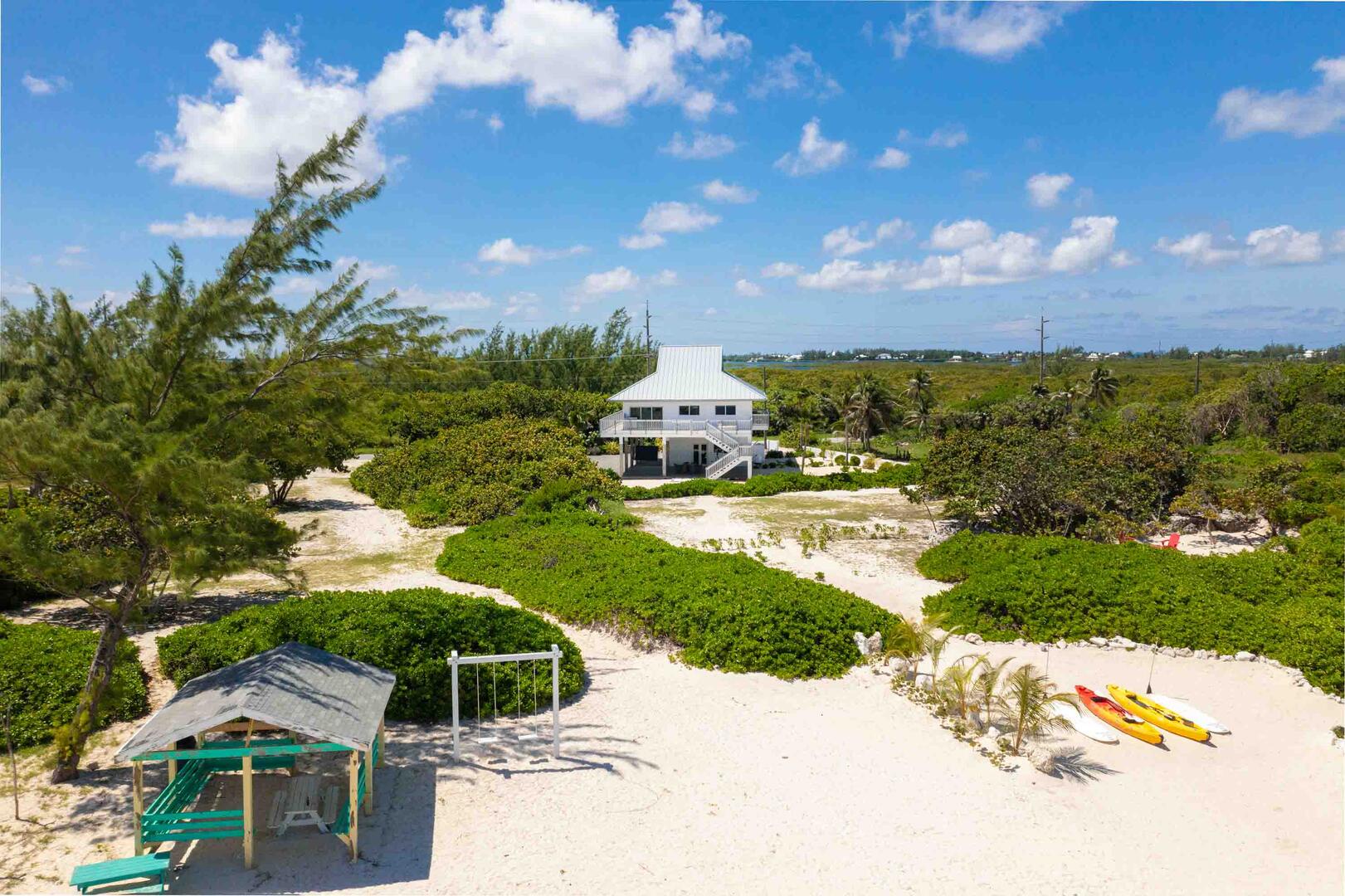The home borders a public beach with a swing set and cabana with a picnic table. Kids and those young at heart will love the swing set by the ocean.