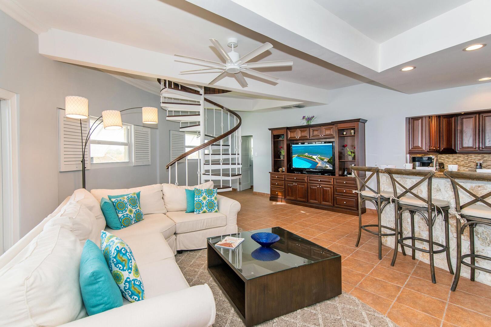 TV viewing area with large flat screen TV and plush sectional sofa.