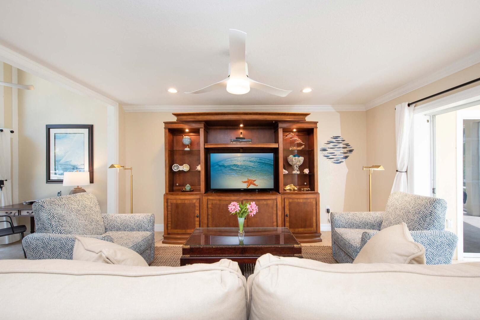 Living area furnished with a sectional sofa and HD cable television.