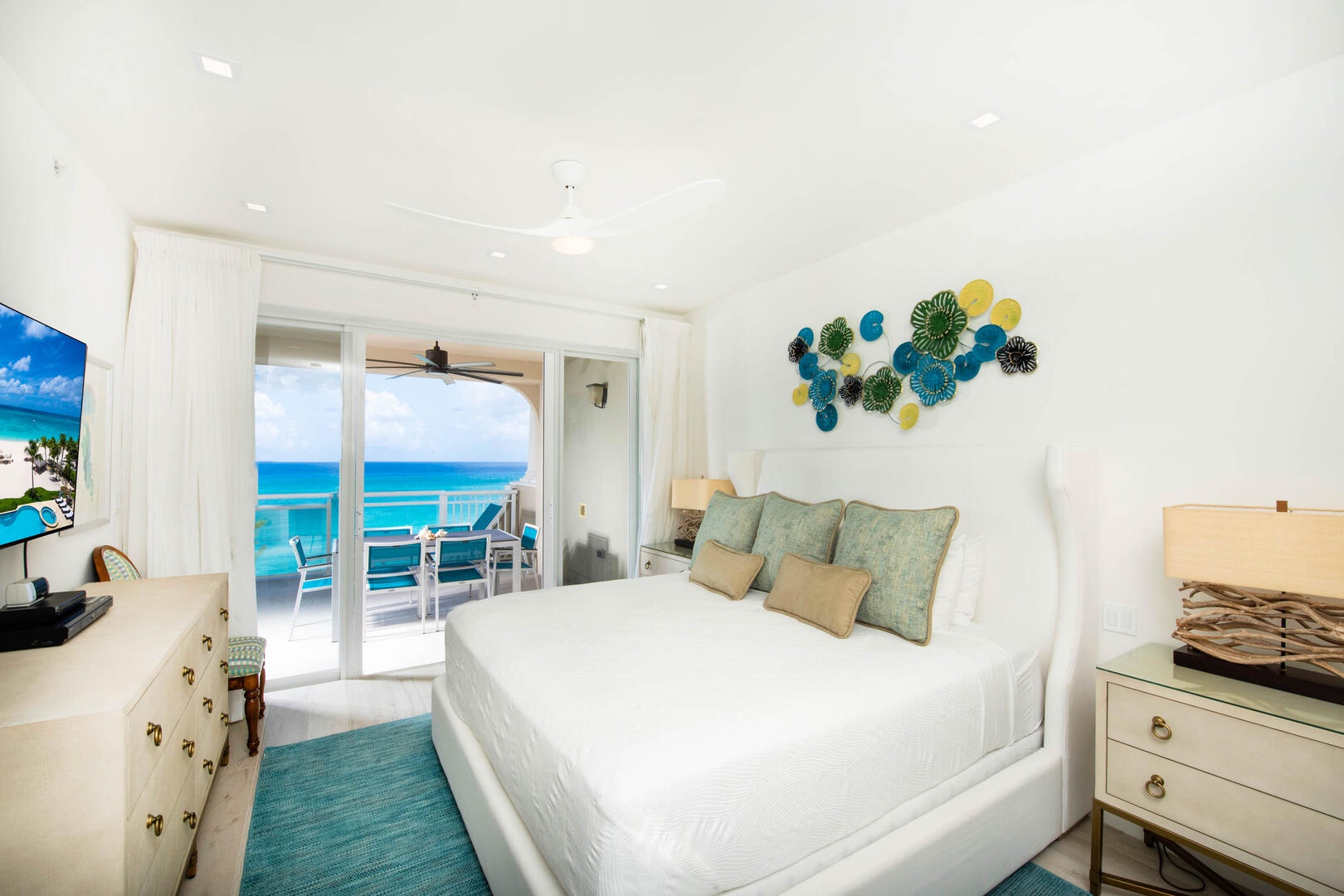 Master suite with king bed, ocean views, and walk-out access to the balcony.