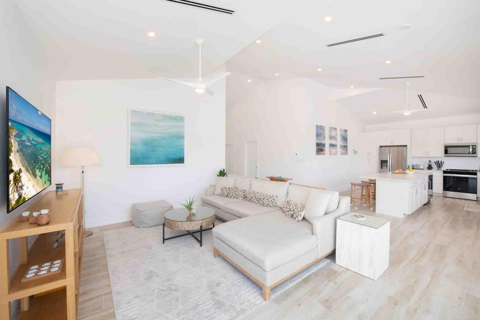 Upper level living area furnished with a sectional sofa and a SmartTV.