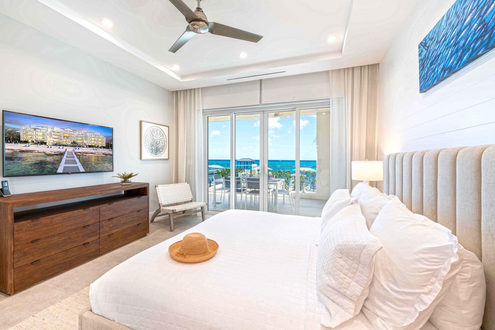 Primary Suite with king bed, television, and walk-out access to the veranda..