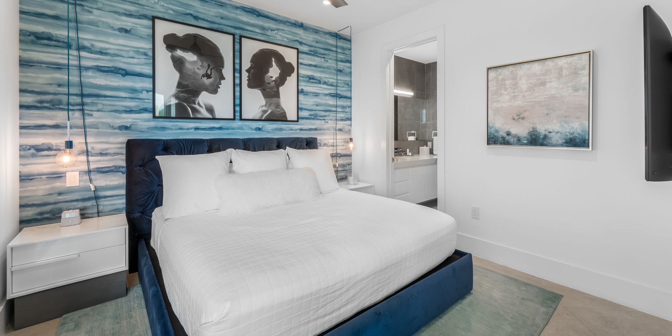 1 of 2 primary suites furnished with a king bed and SmartTV.