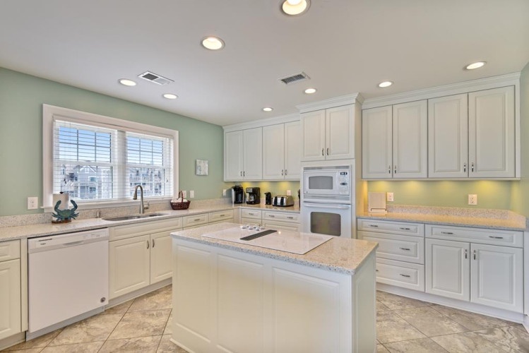 Your spacious kitchen features granite countertops, a large center island, and modern appliances—ready for you to prepare meals and entertain with ease.