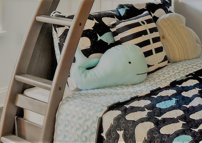 Cozy bunk beds dressed in playful patterns and plush friends create the perfect space for little ones to rest and dream.