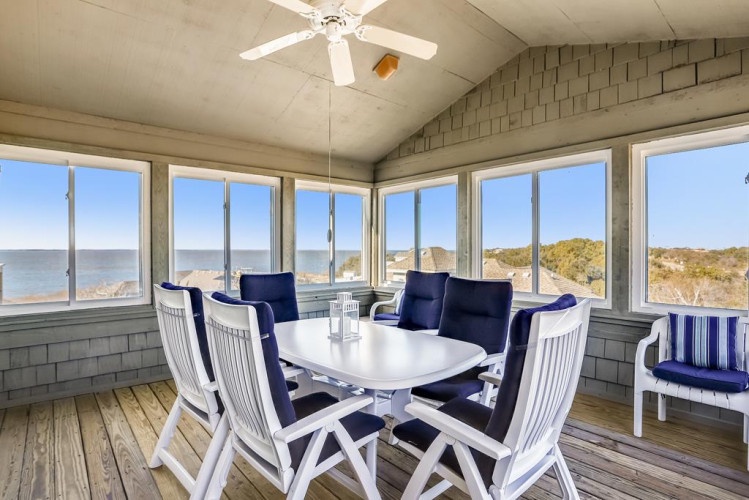 Picture yourself dining here with panoramic sea views stretching endlessly before you. This bright, enclosed porch offers comfortable seating and refreshing coastal breezes—your perfect spot to relax and soak in the scenery.