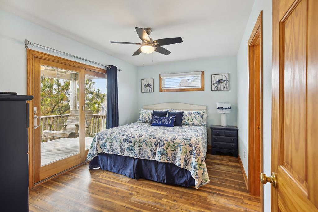 Drift off to coastal dreams in your serene bedroom, where natural light and ocean breezes flow through sliding glass doors. Wake up refreshed, step onto your private balcony, and savor peaceful mornings overlooking the pines.