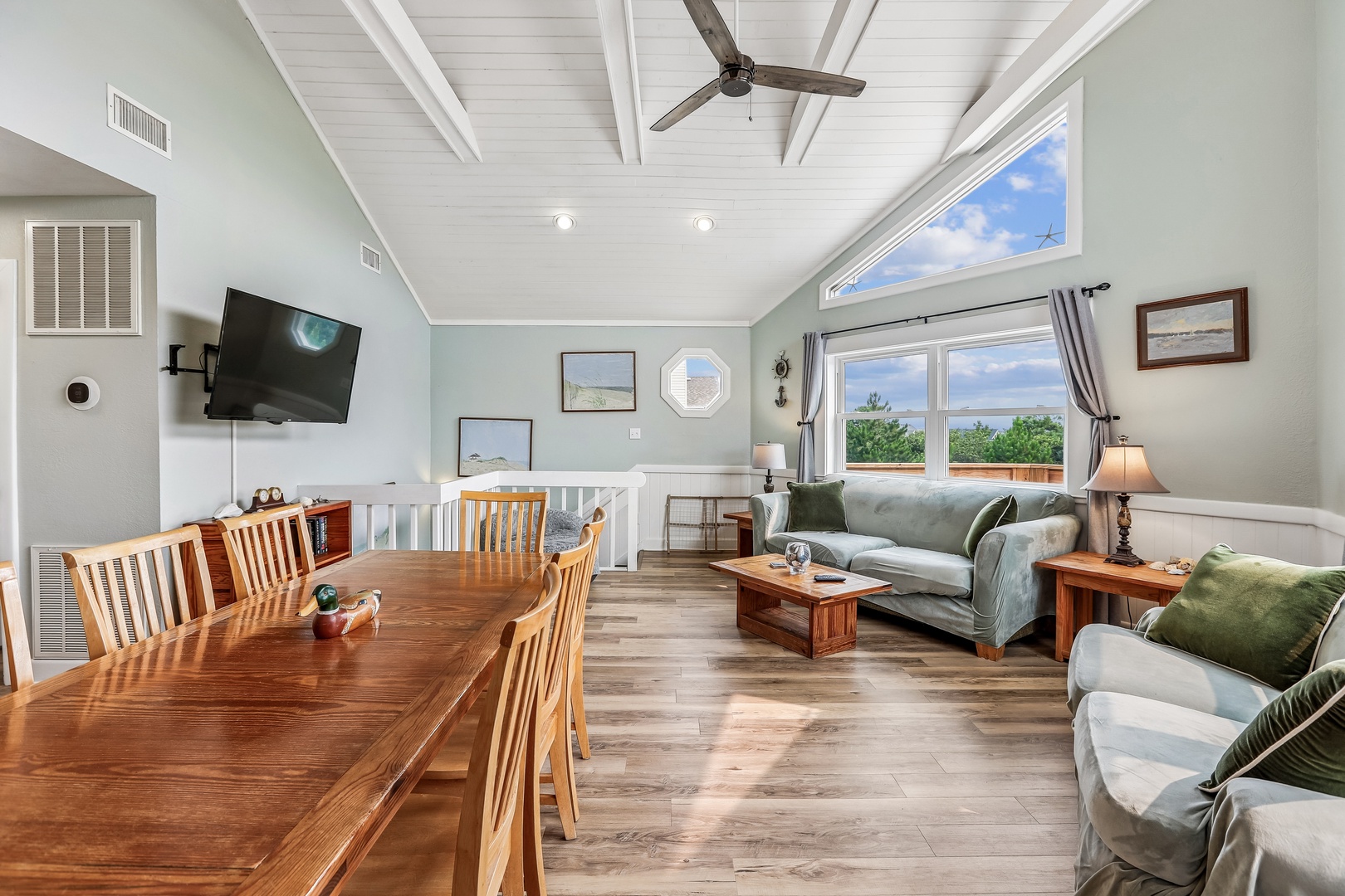 Gather around the beautiful wood dining table or sink into plush sofas with your favorite people. Natural light pours through large windows, while vaulted ceilings and coastal touches create an airy, welcoming retreat for your group.