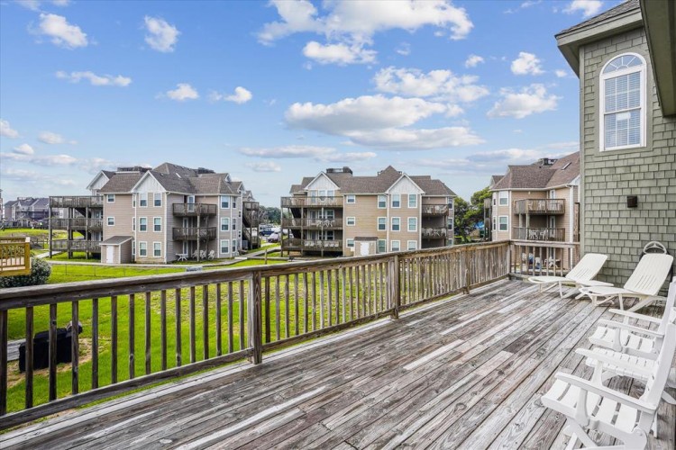 Your private deck overlooks a peaceful residential neighborhood, perfect for morning coffee or afternoon relaxation under open skies.