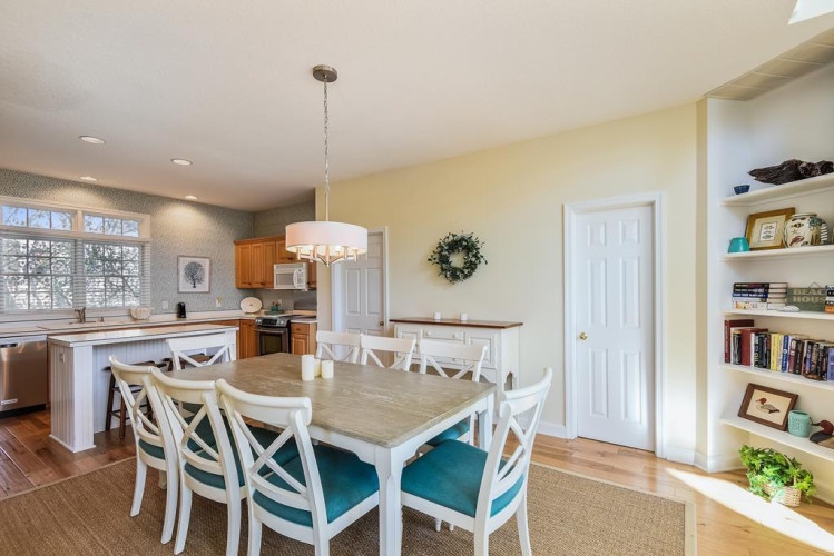 Gather around this inviting dining table where your group can share meals and create memories. The open layout connects seamlessly to the fully equipped kitchen, perfect for home-cooked dinners.