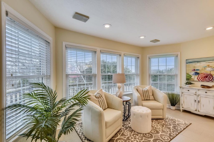 Unwind in your bright, airy sitting room with comfy chairs, abundant natural light, and views of the surrounding neighborhood.