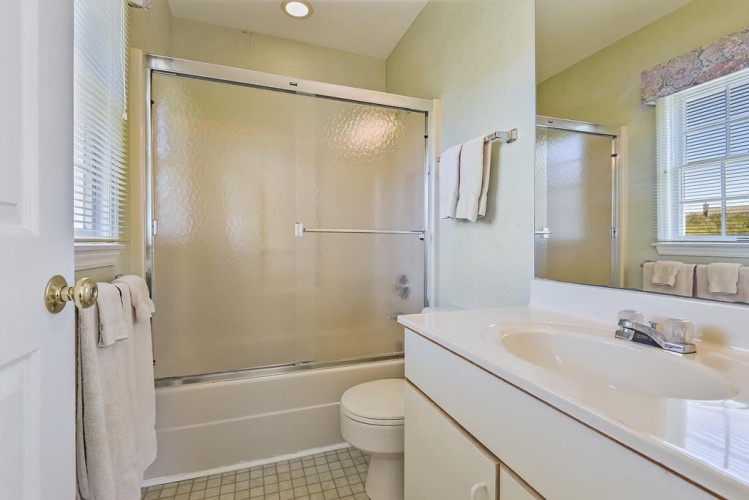 Your private bathroom features a refreshing tub-shower combo, fresh towels, and ample counter space for your toiletries—everything you need for a comfortable, relaxing stay.