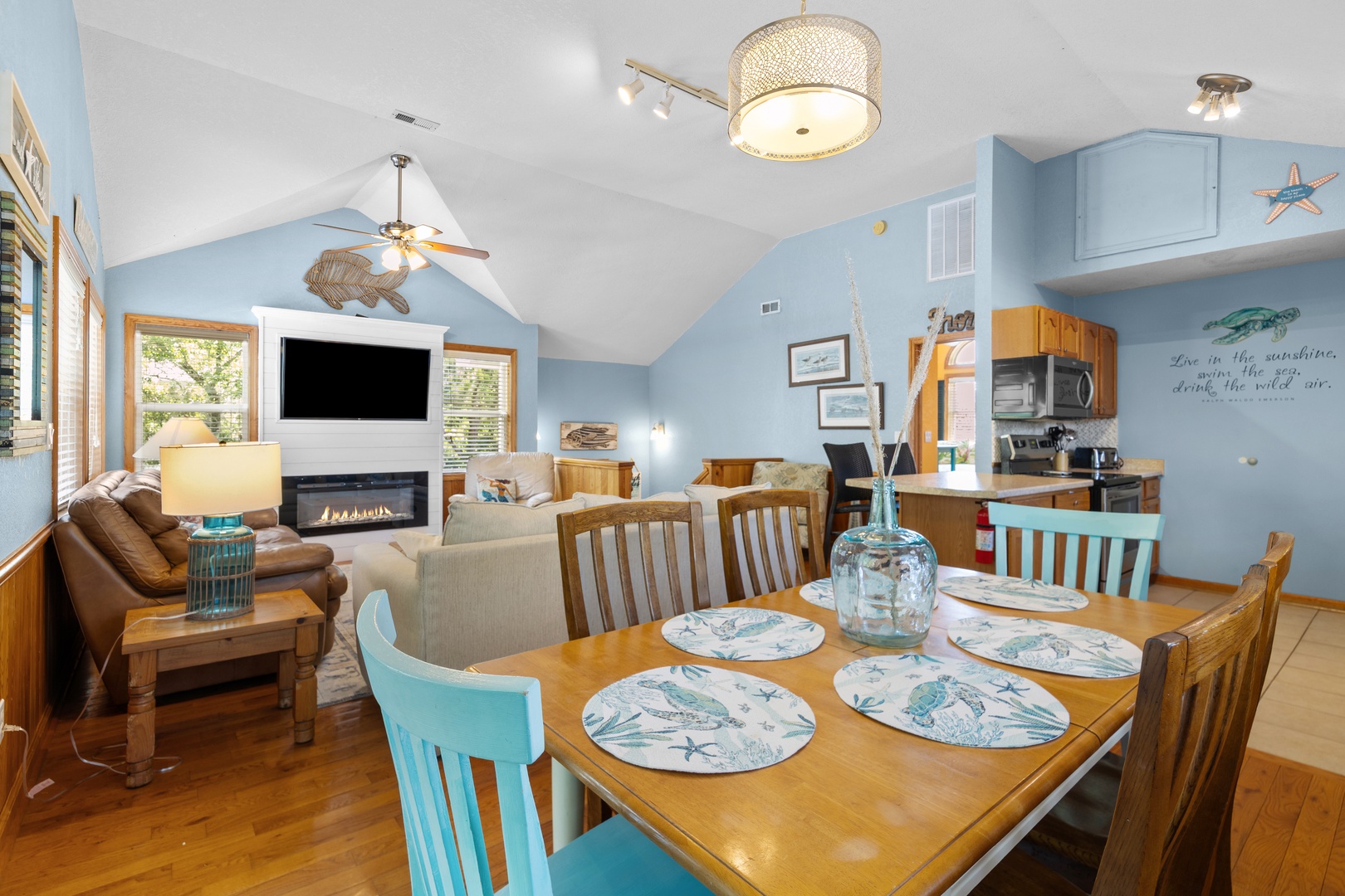 Your beach-themed retreat features an open living space with cozy fireplace, dining for six, and a fully-equipped kitchen—perfect for gathering after a day exploring the coast.